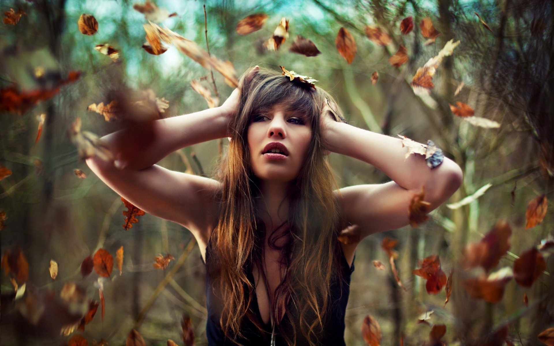 Woman with hands on head in autumn forest HD Wallpaper