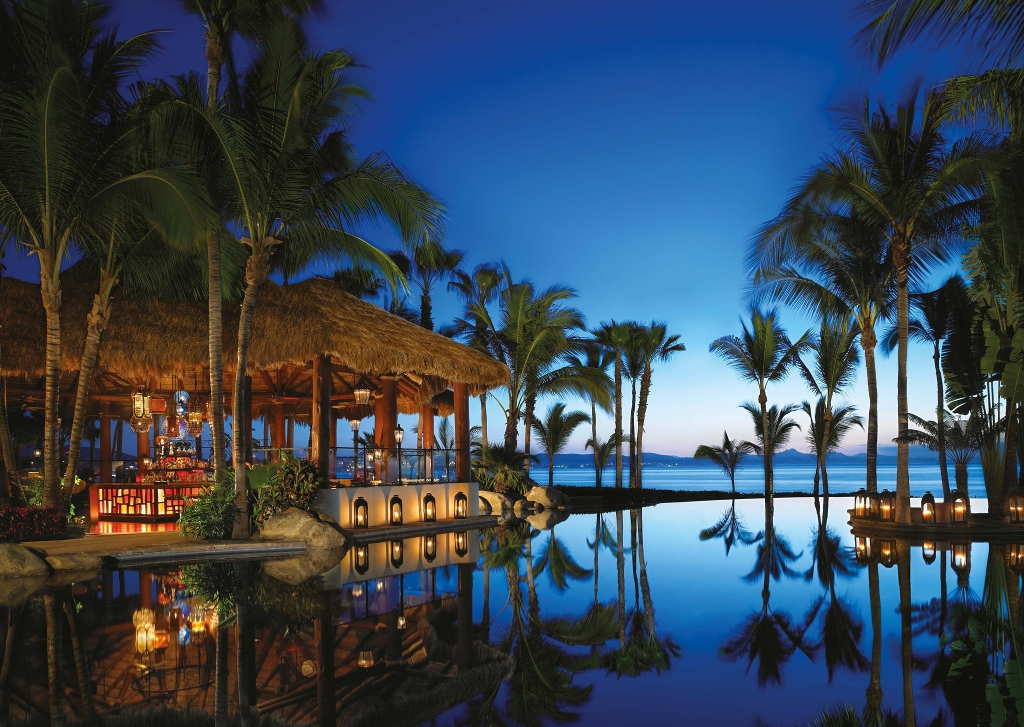 Tropical resort bar with infinity pool at dusk HD Wallpaper