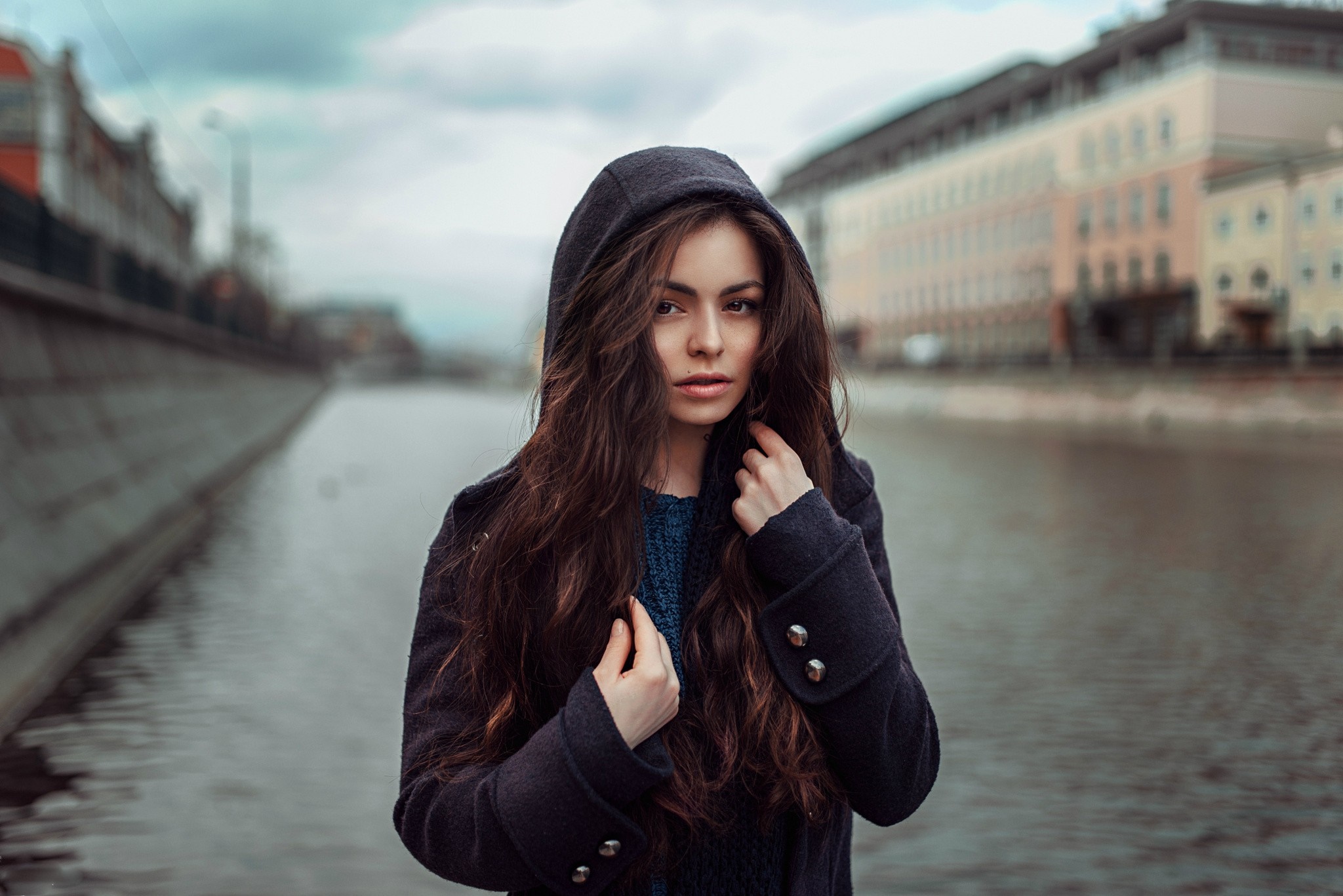 Woman in a hooded coat by a canal HD Wallpaper