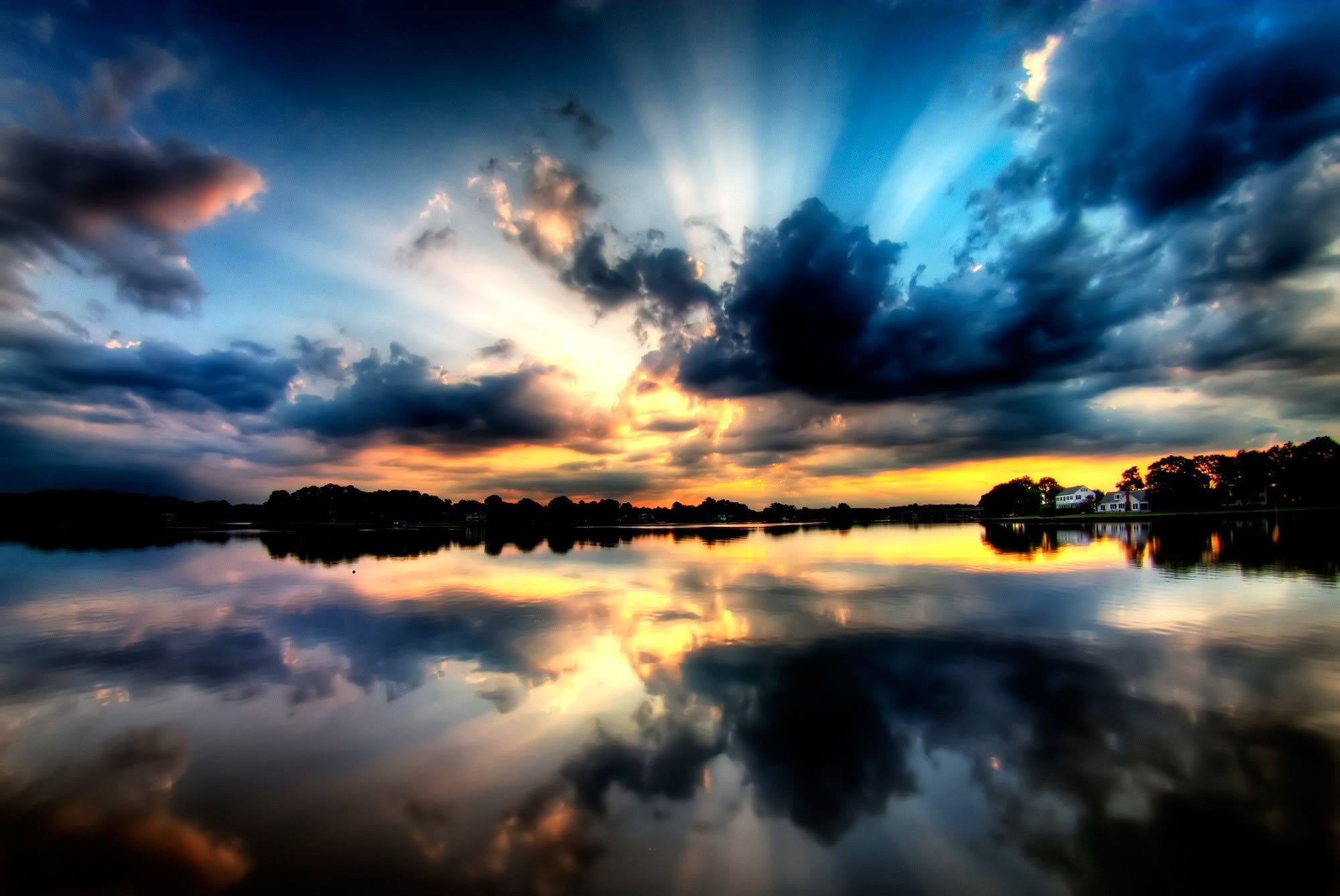 Sunset over a lake with sun rays and reflections HD Wallpaper