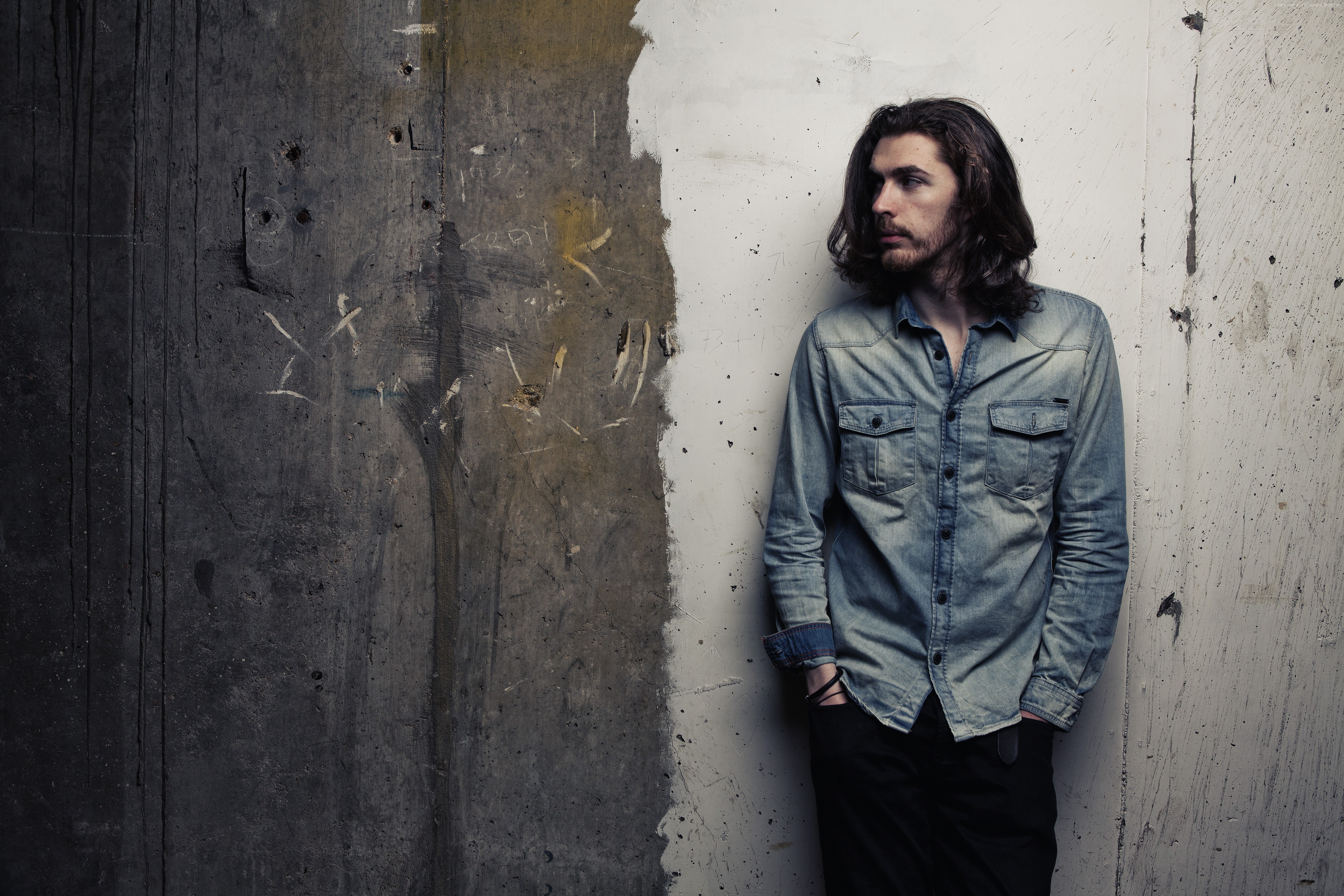 Hozier standing against a textured wall HD Wallpaper
