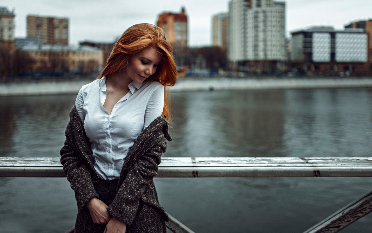 Woman with red hair wearing a white shirt and coat on a bridge HD Wallpaper