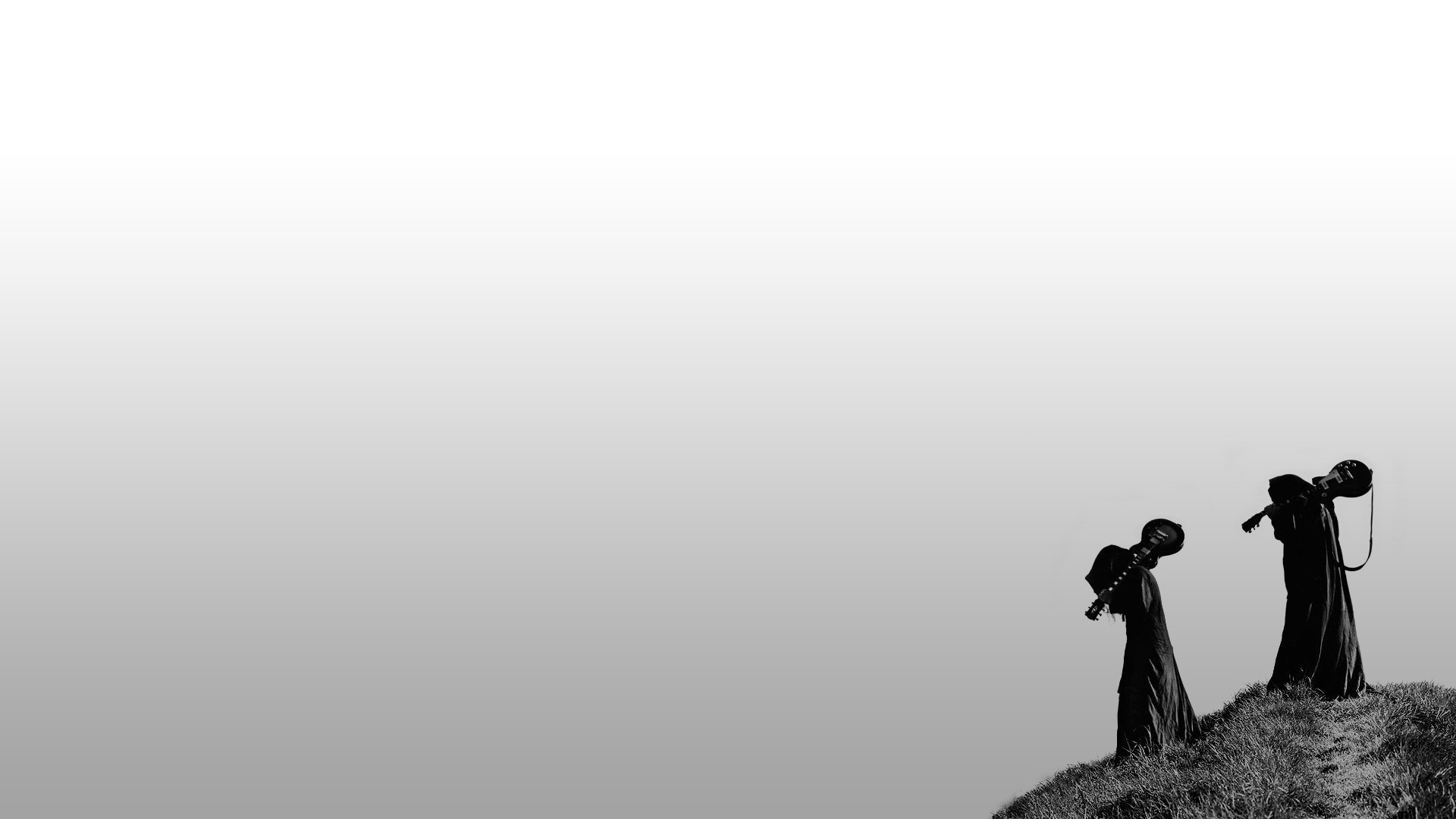 Two figures in silhouette carrying guitars on a grassy hill HD Wallpaper
