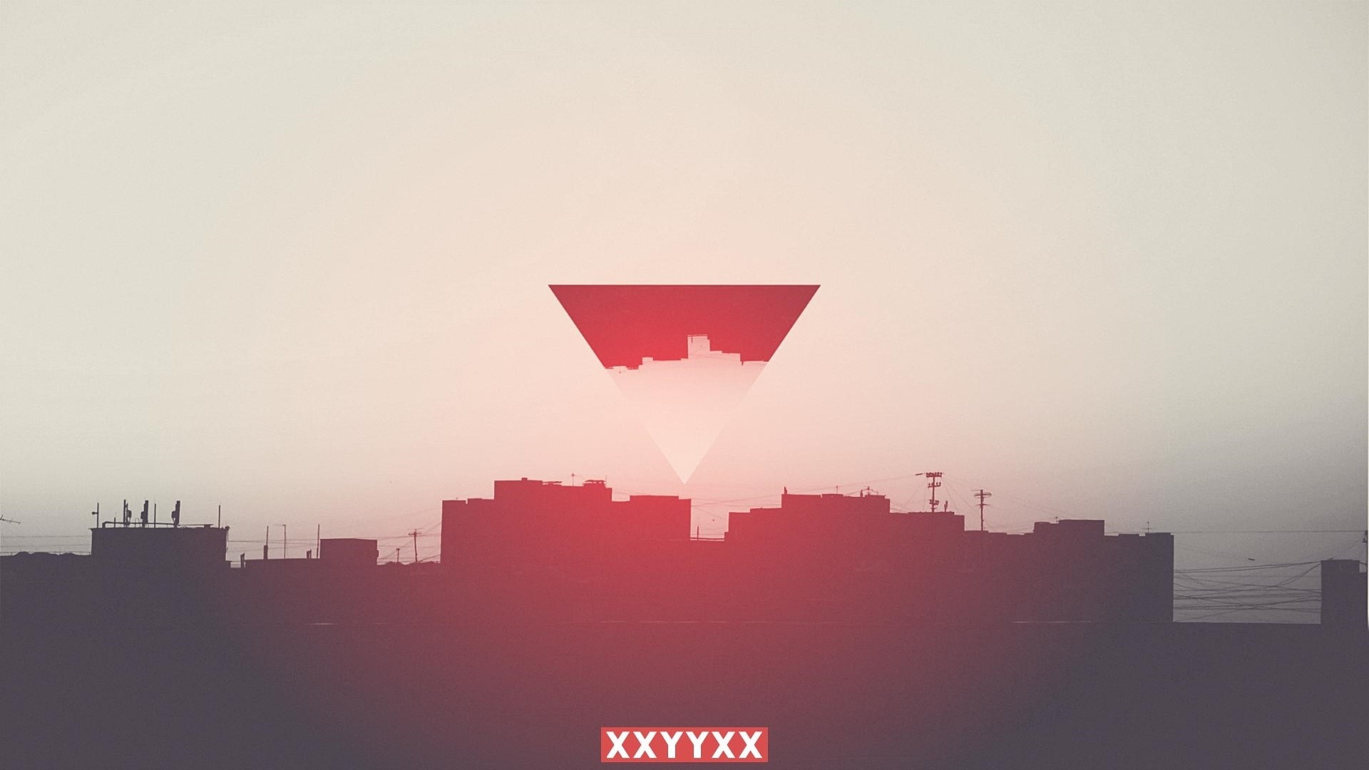 Cityscape silhouette with red triangle and text HD Wallpaper