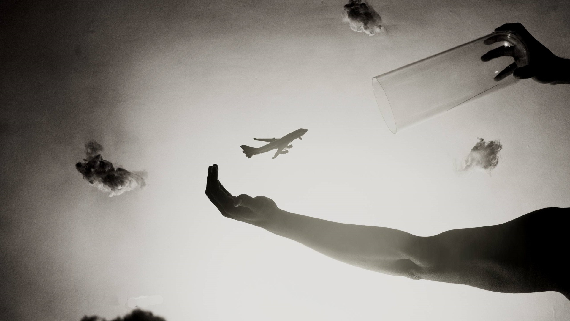 Monochrome photography of hands holding airplane with clouds HD Wallpaper