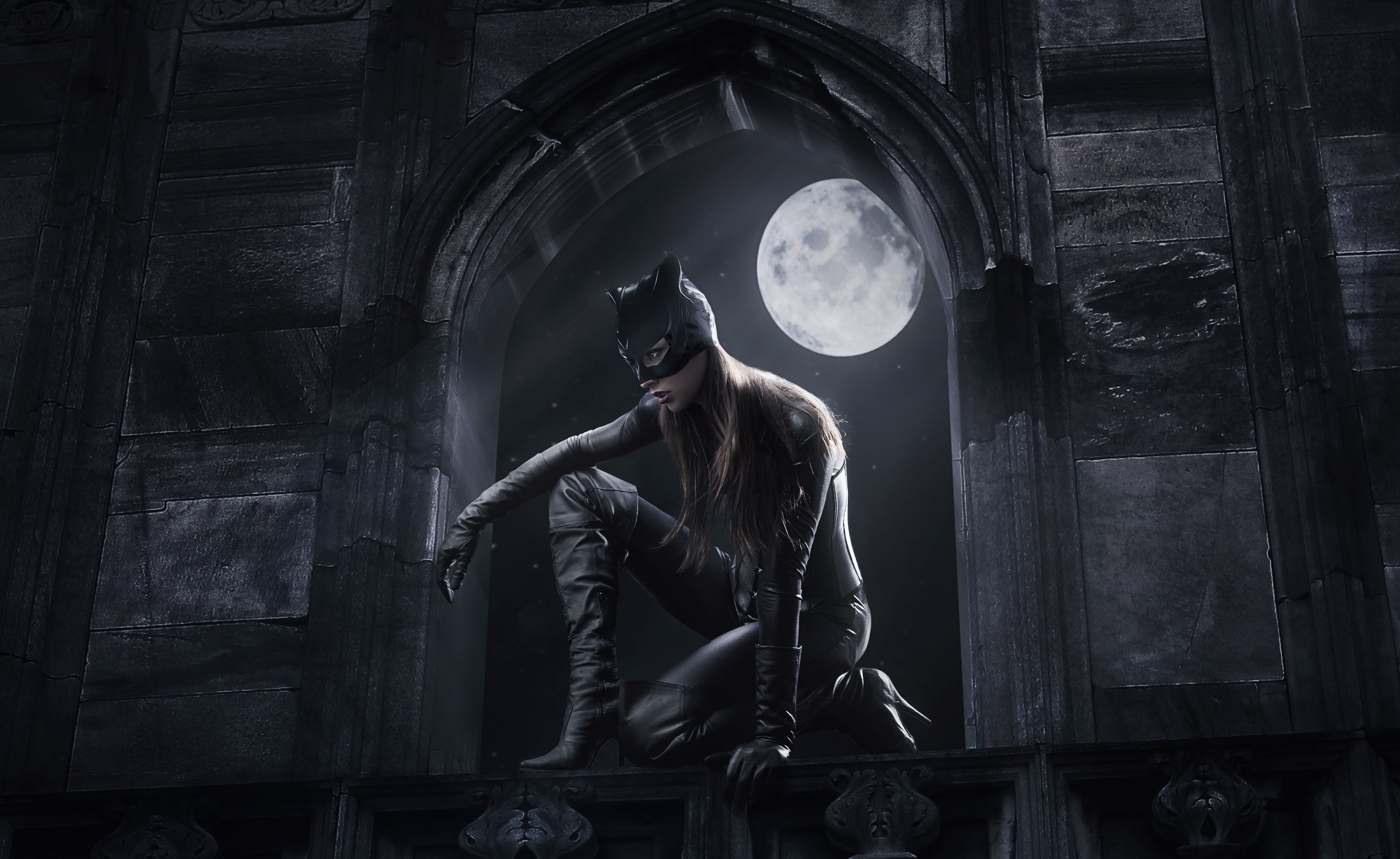 Catwoman in a black suit crouching on a ledge at night HD Wallpaper
