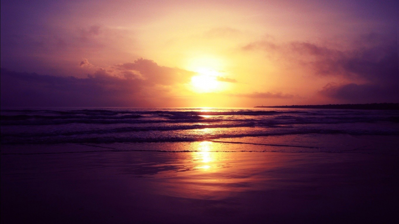 Sunset over the ocean with reflection on the beach HD Wallpaper