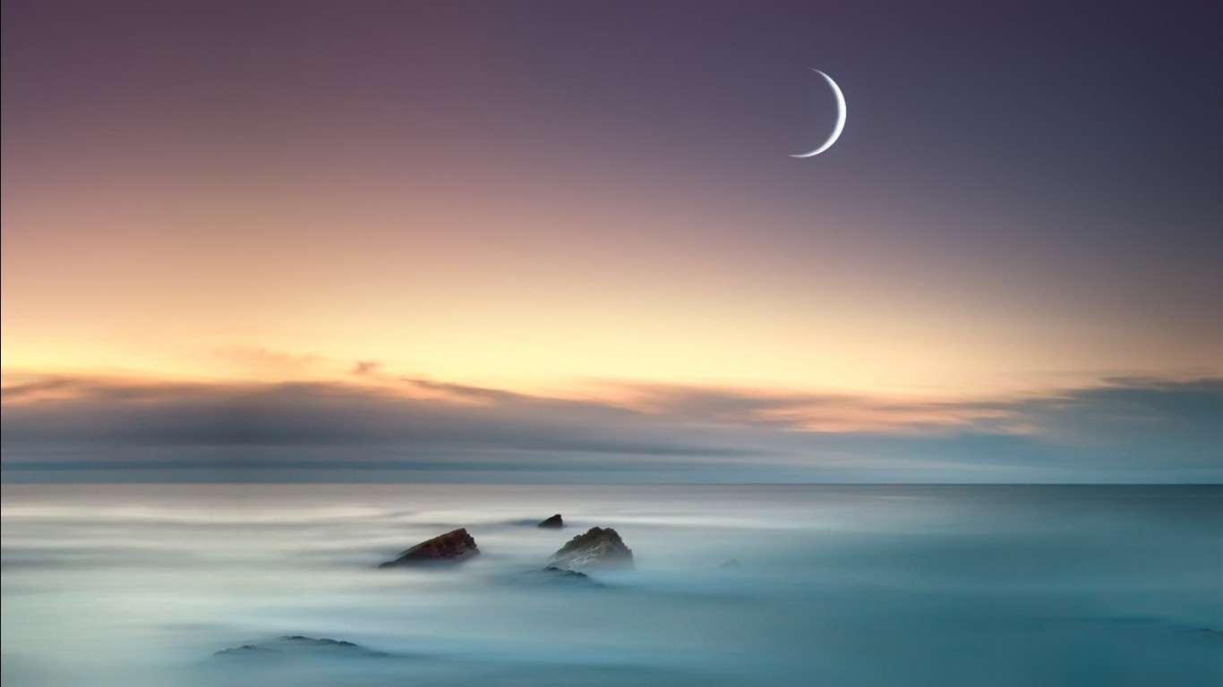 Crescent moon over the ocean at sunrise with rocks HD Wallpaper