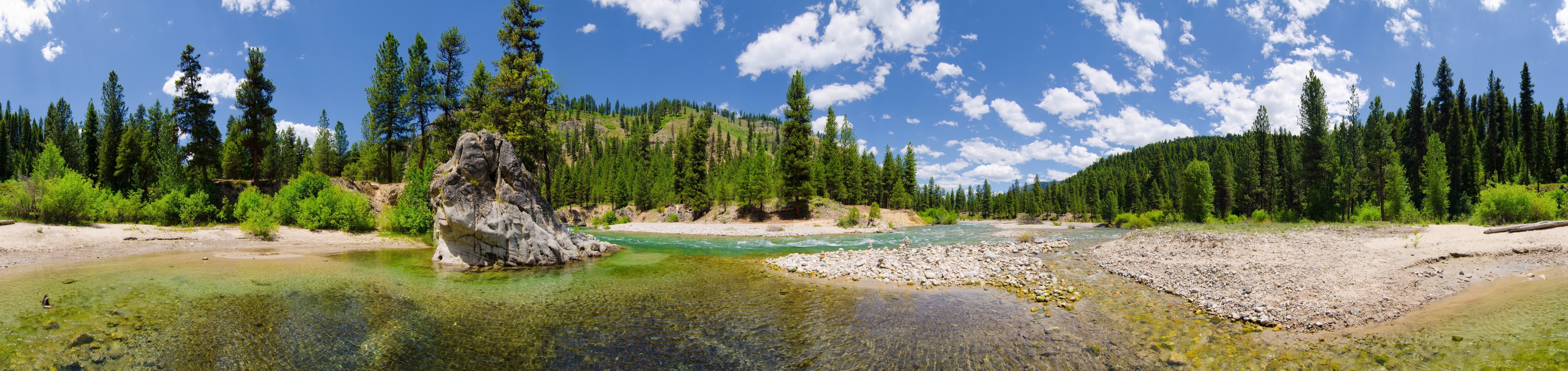 Panoramic view of a river flowing through a forest with hills HD Wallpaper