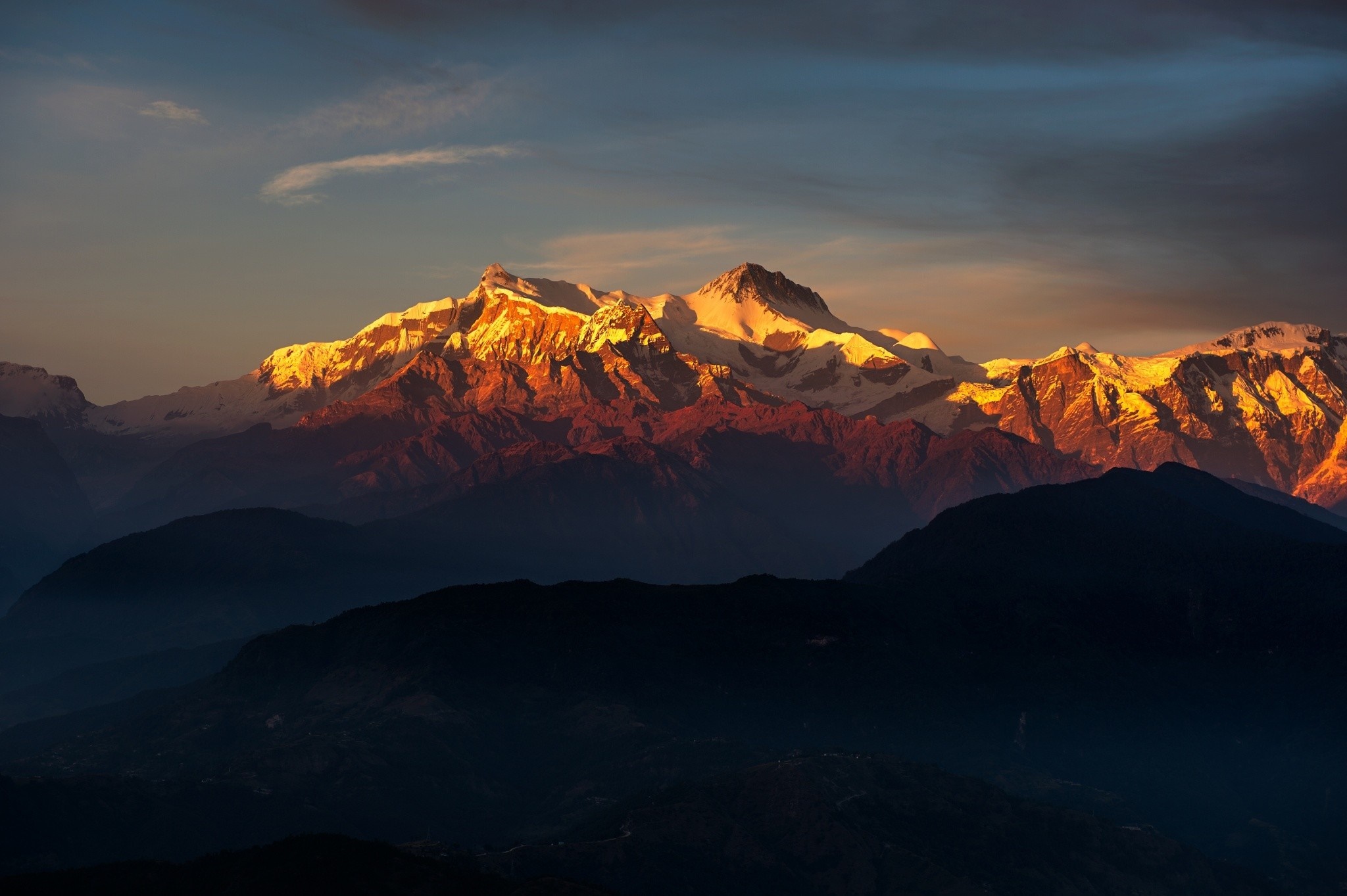Golden sunlight illuminates snow-capped Himalayas at sunset HD Wallpaper
