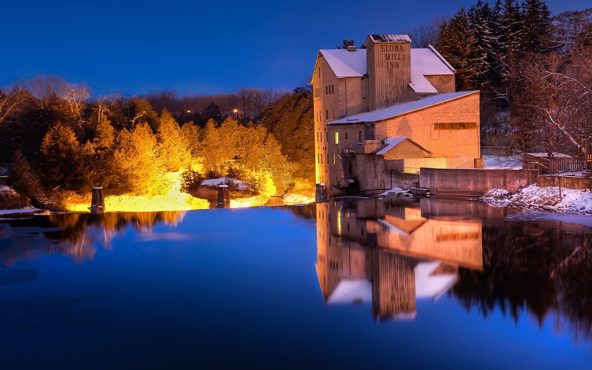 Elora Mill Inn reflected in water during winter evening HD Wallpaper