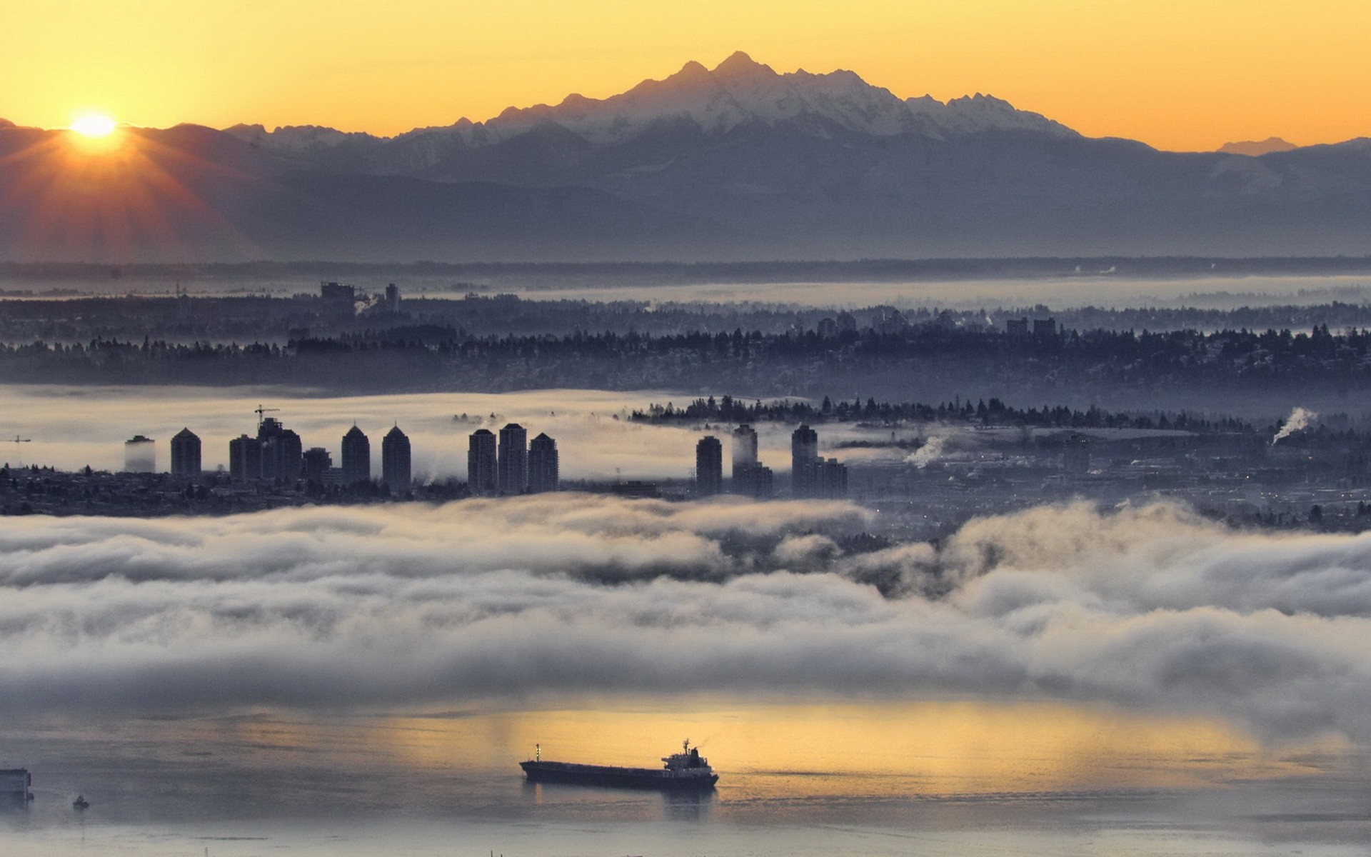 Vancouver cityscape at sunrise with mountains and fog HD Wallpaper