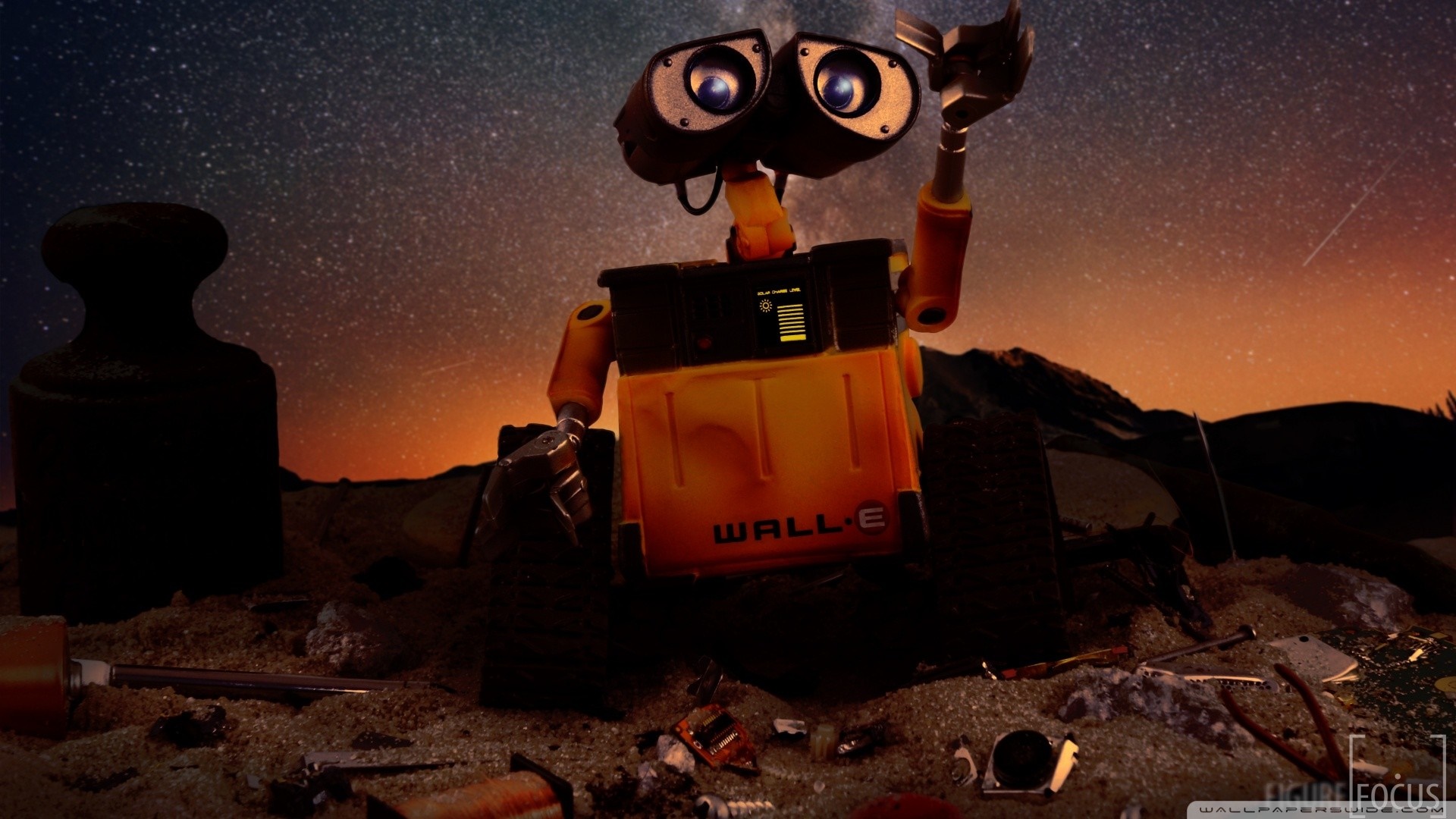 WALL-E robot on a trash-filled planet at night HD Wallpaper