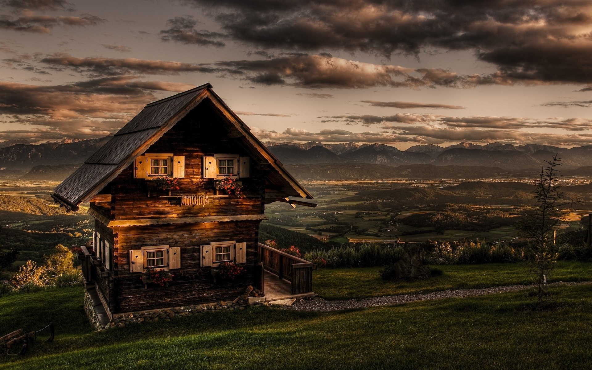 Wooden house on a hill overlooking a valley at sunset HD Wallpaper