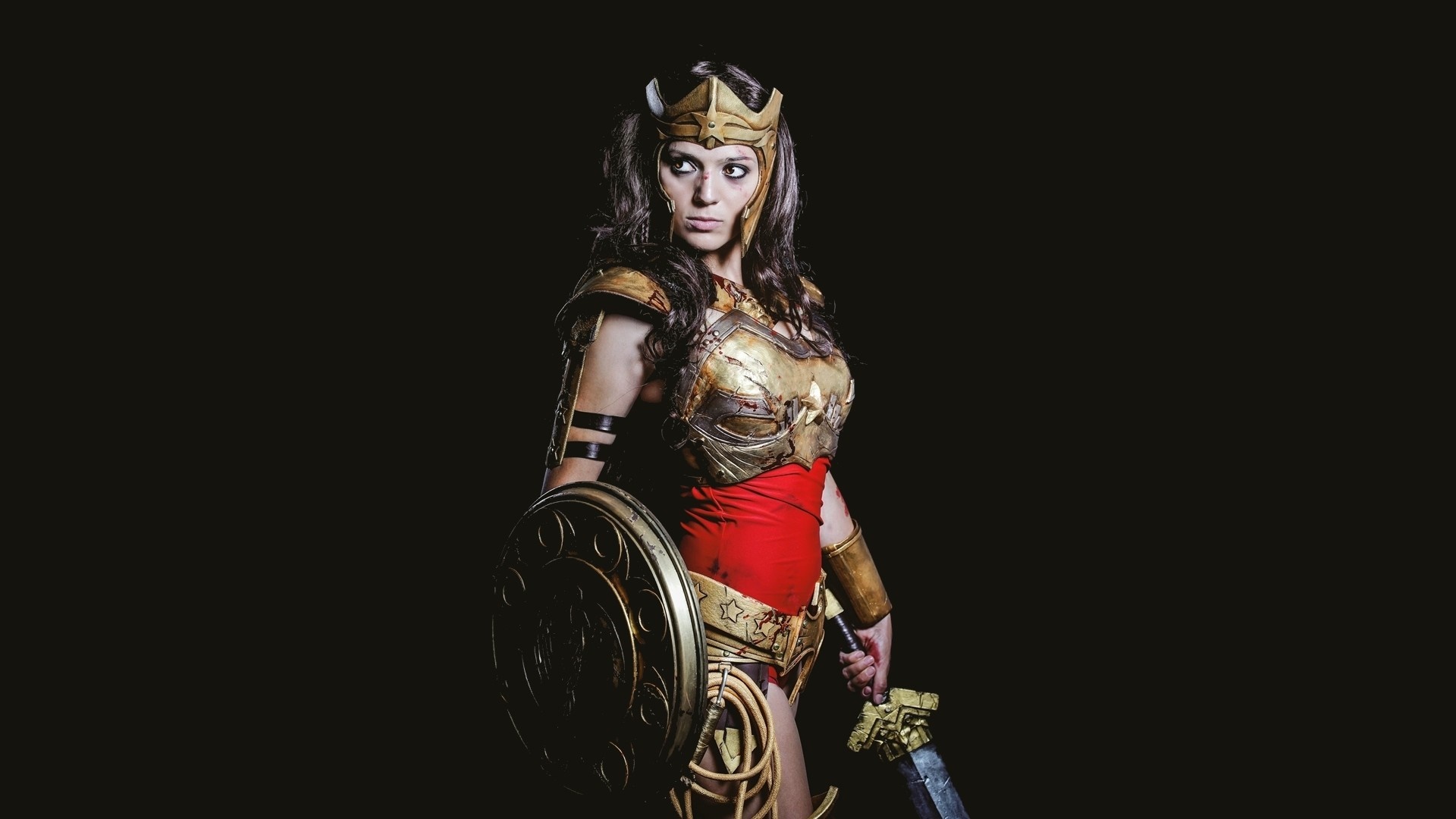 Woman dressed as Wonder Woman with sword and shield HD Wallpaper