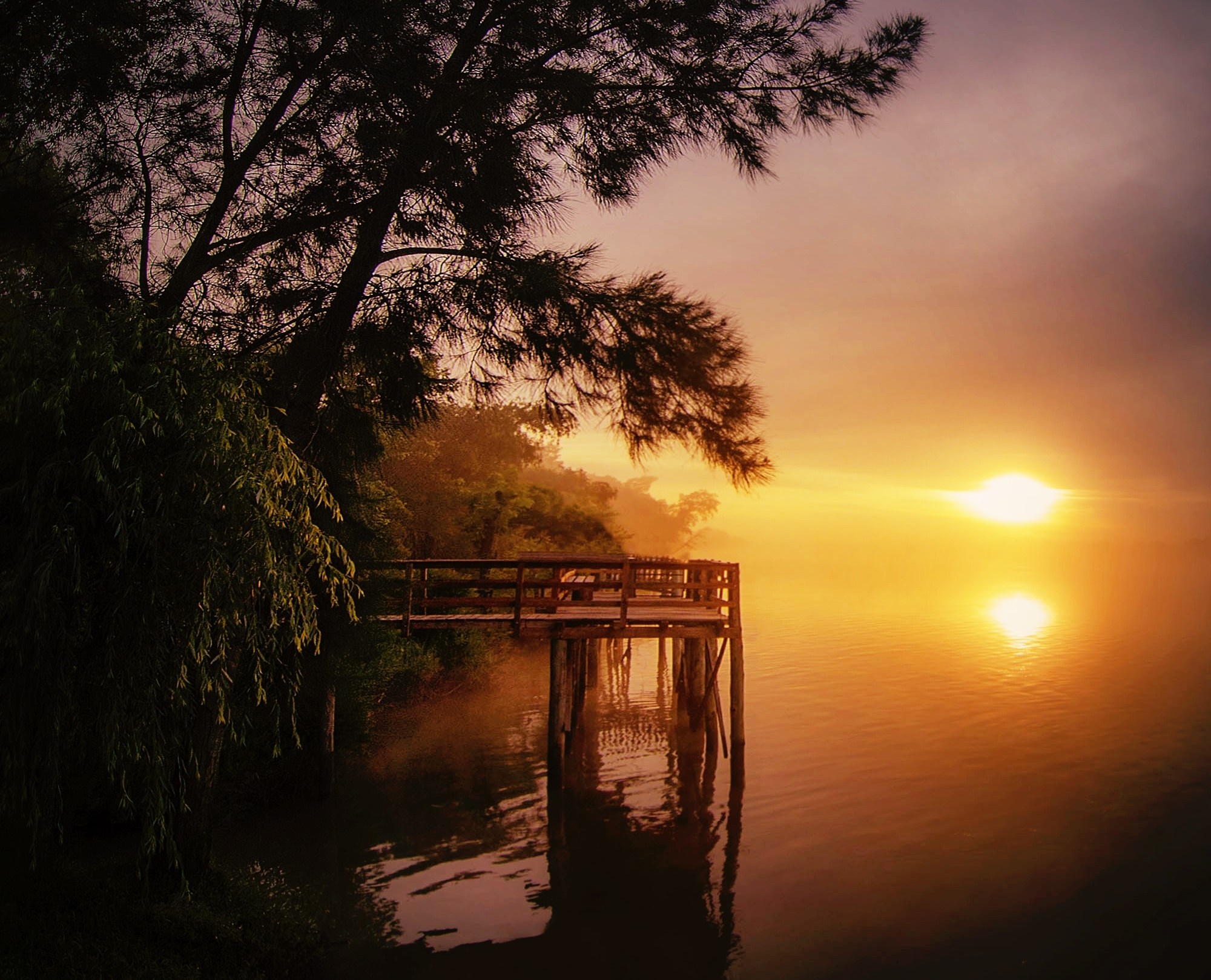 Sunrise over a misty lake with a wooden pier HD Wallpaper