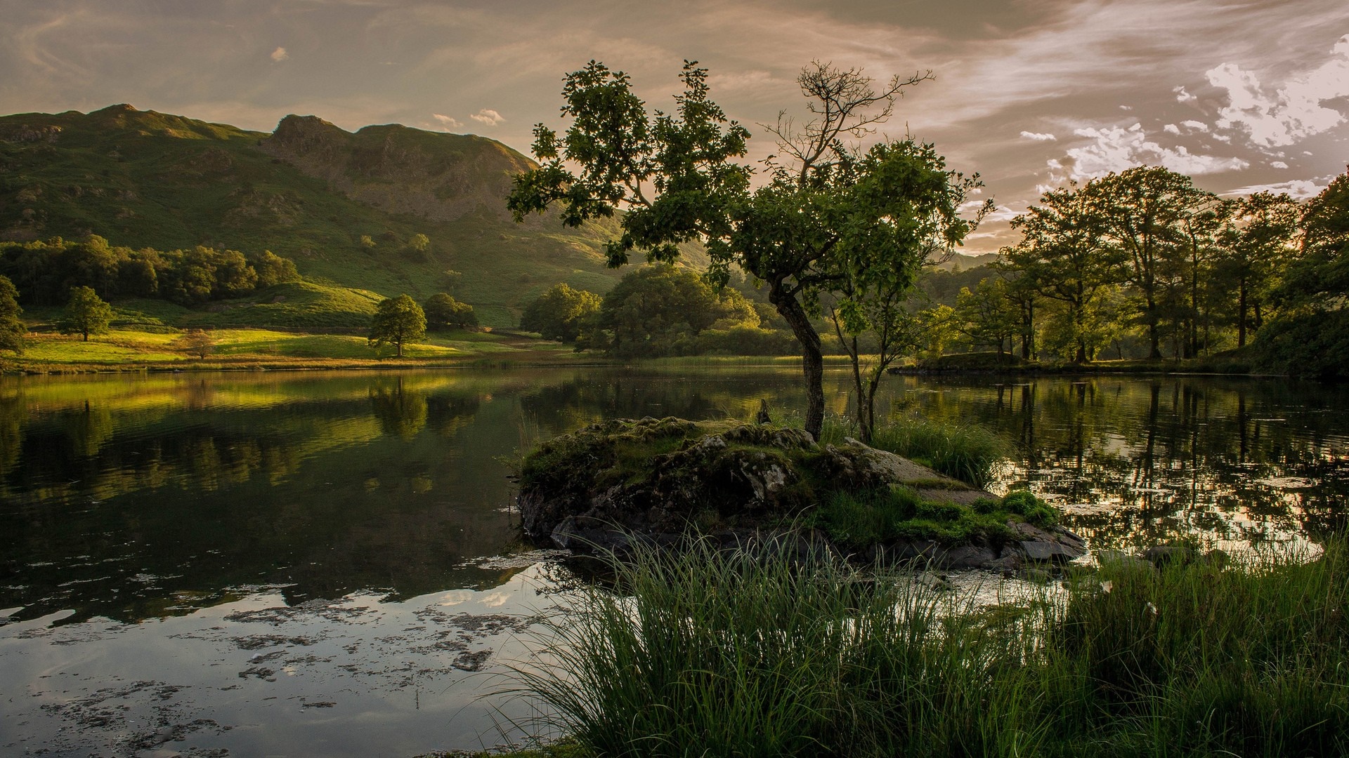 Lake reflection with trees and hills at sunrise HD Wallpaper