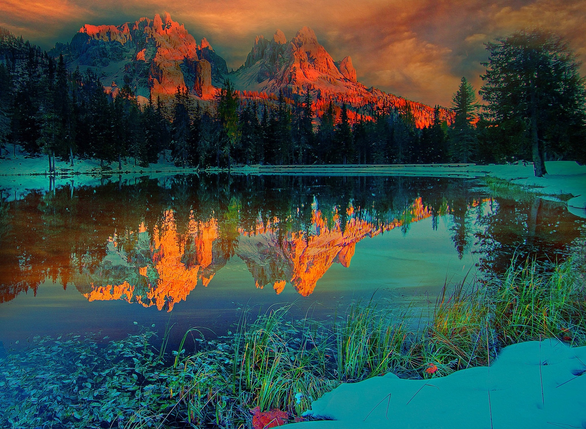 Mountain range reflected in a lake at sunset HD Wallpaper