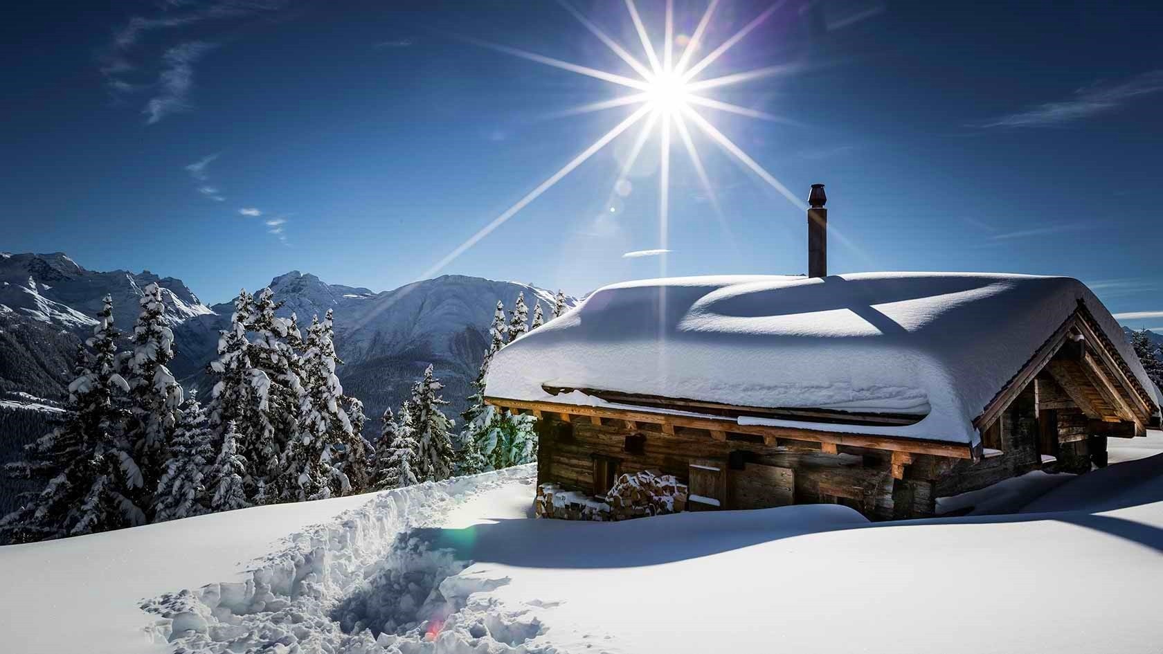 Snowy cabin in the mountains with sun HD Wallpaper