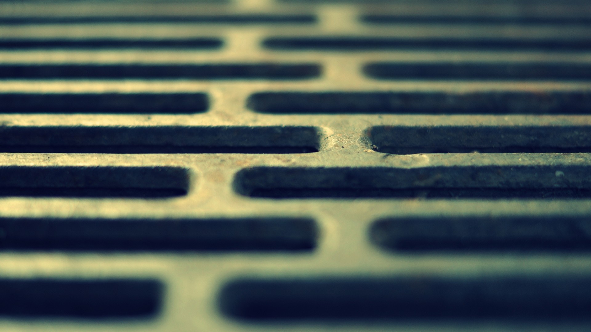 Close-up of a metal grate with a repeating pattern HD Wallpaper