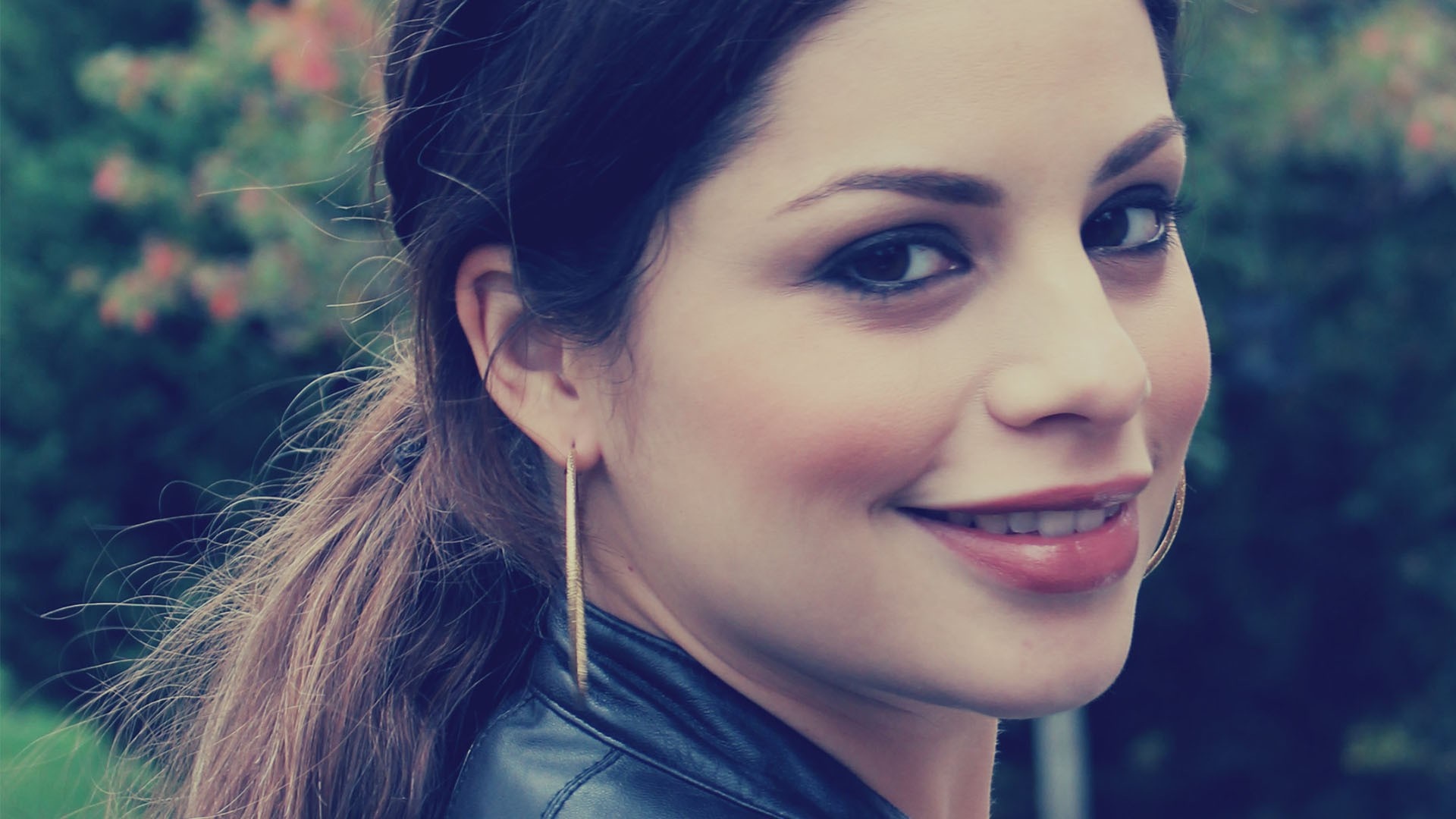 Woman with brown hair and gold earring smiling HD Wallpaper