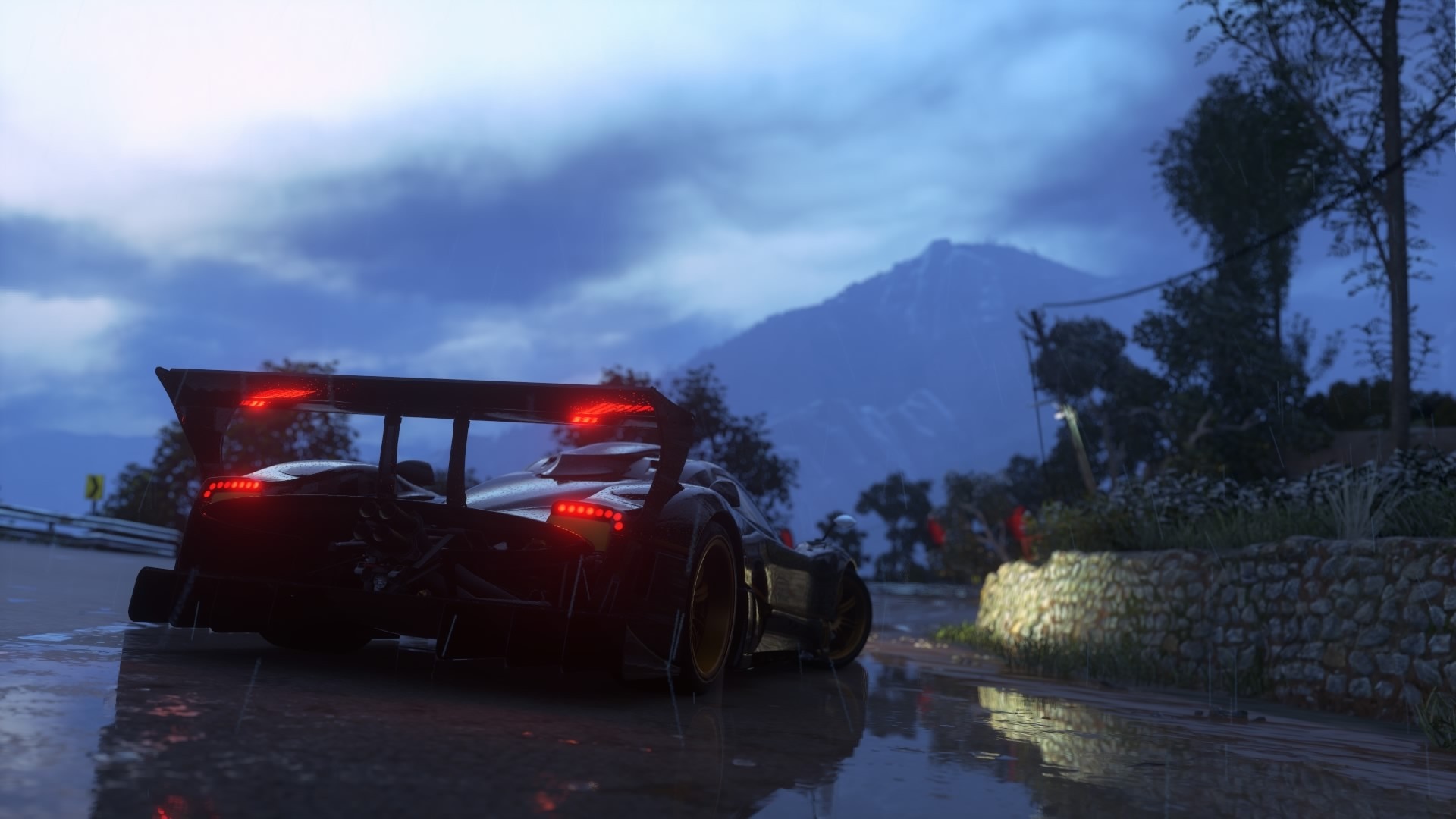 Pagani Zonda R driving on a wet road in the mountains HD Wallpaper