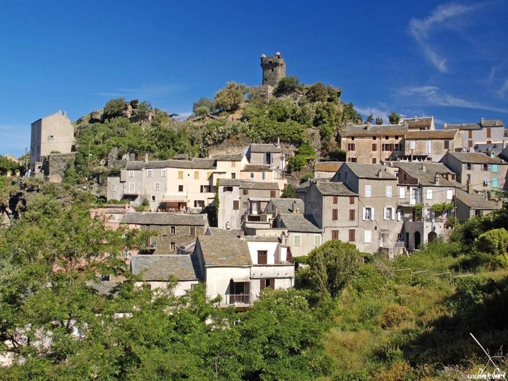 Village with castle on a hill under a blue sky HD Wallpaper