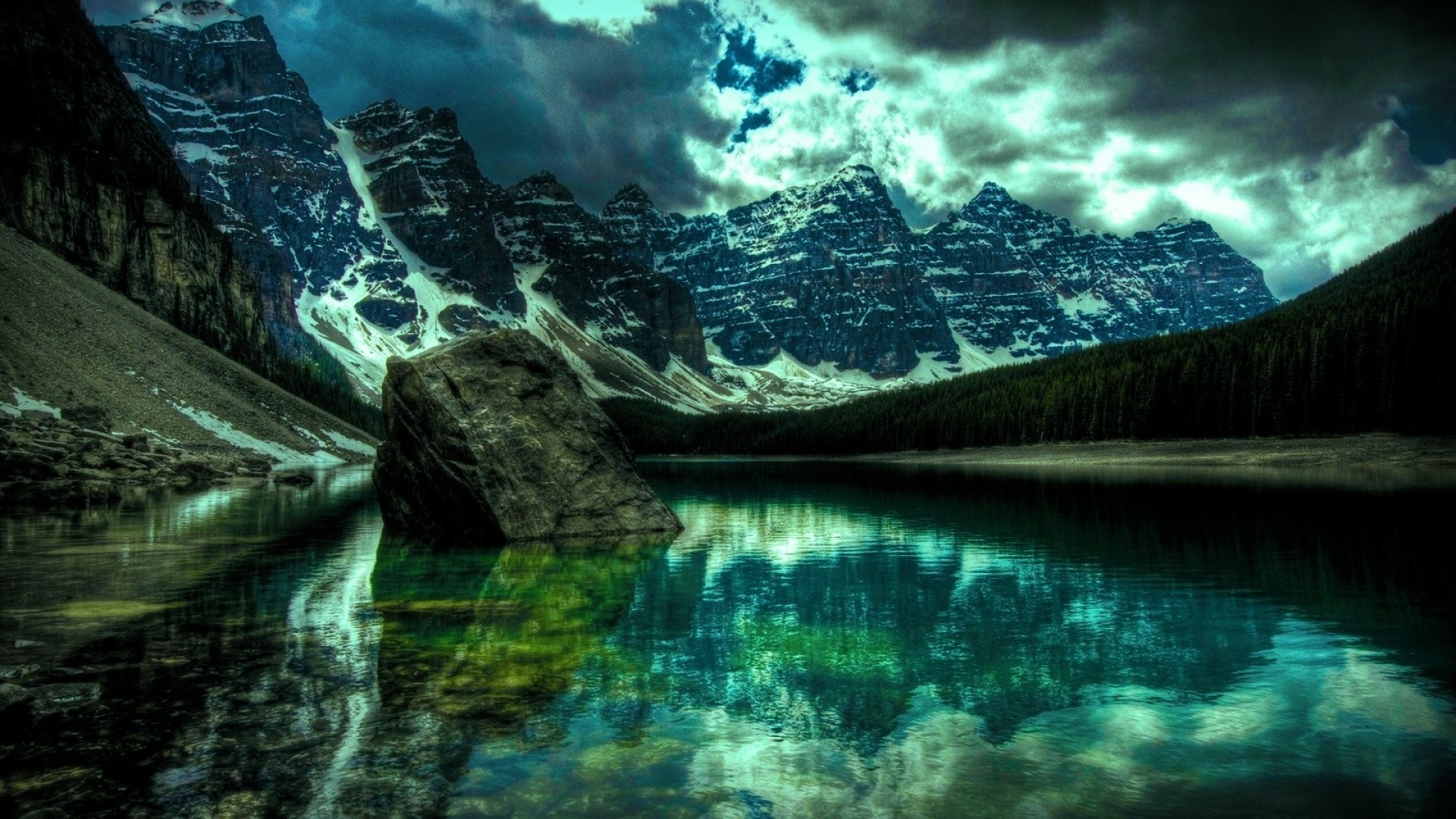 Mountains reflected in a dark lake under a stormy sky HD Wallpaper
