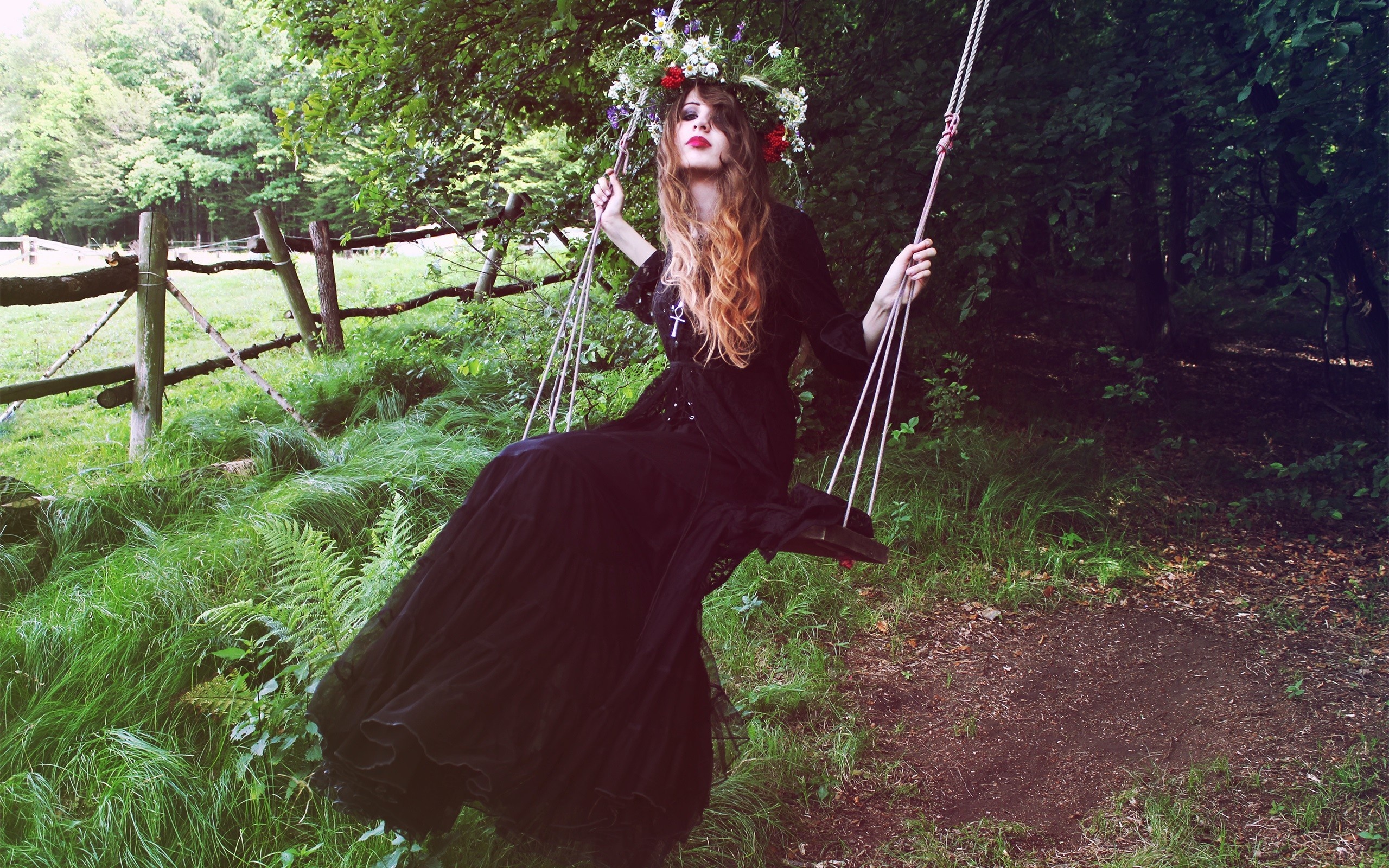 Woman in black dress on a swing in a forest HD Wallpaper