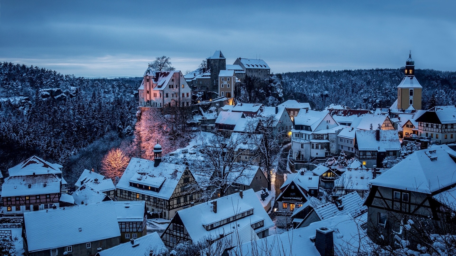 Snow-covered town with castle and church in winter HD Wallpaper