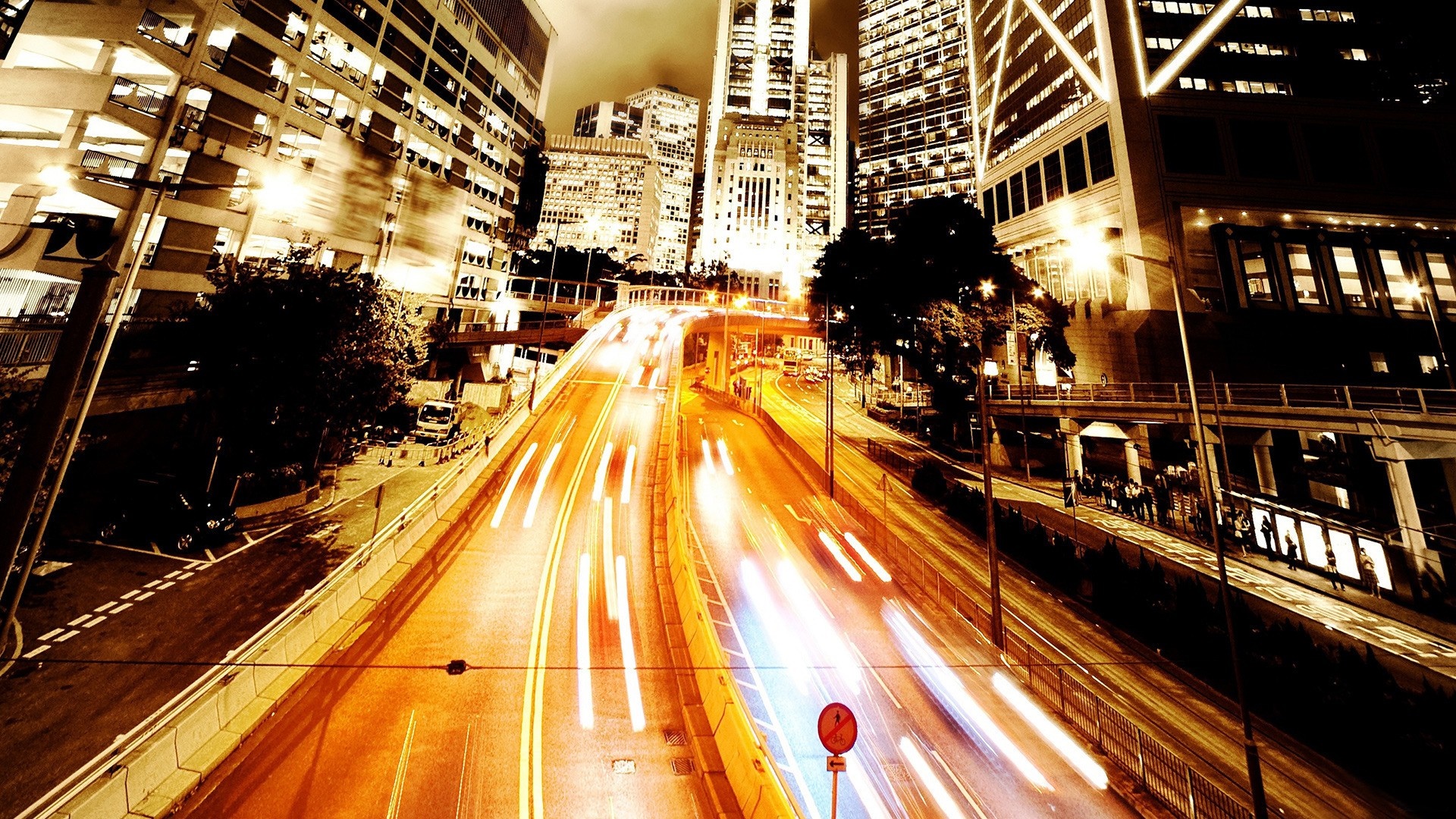 City street at night with light trails from traffic HD Wallpaper