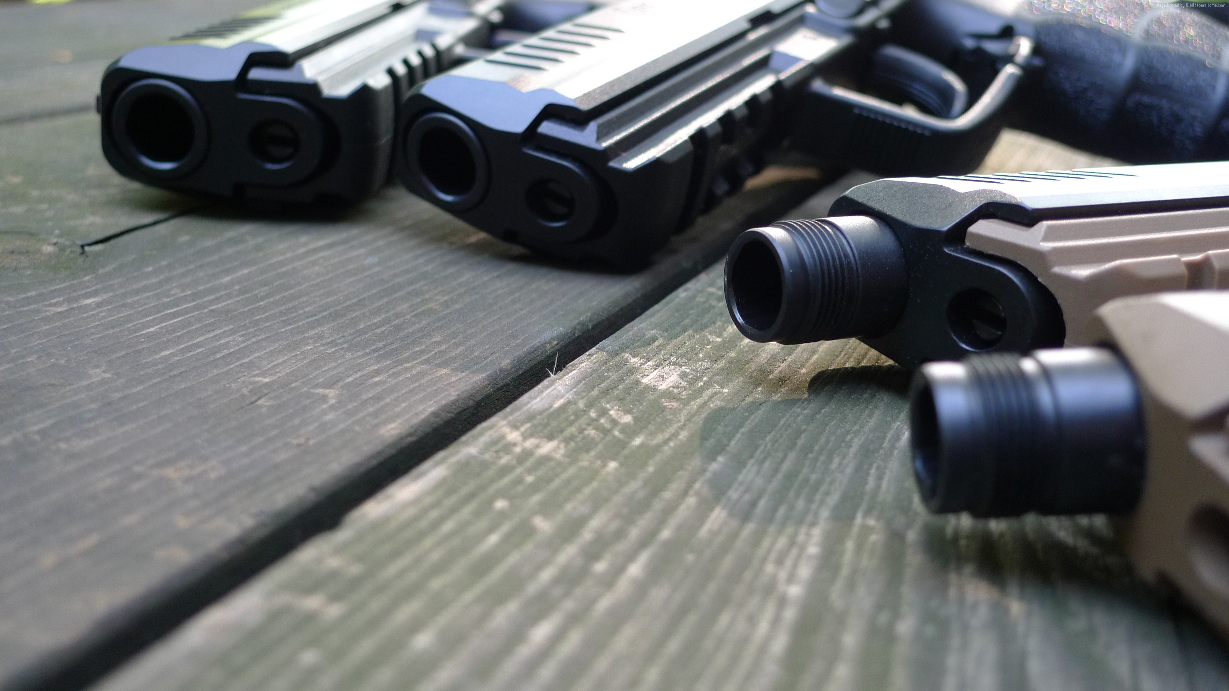 Multiple handguns on a wooden table HD Wallpaper
