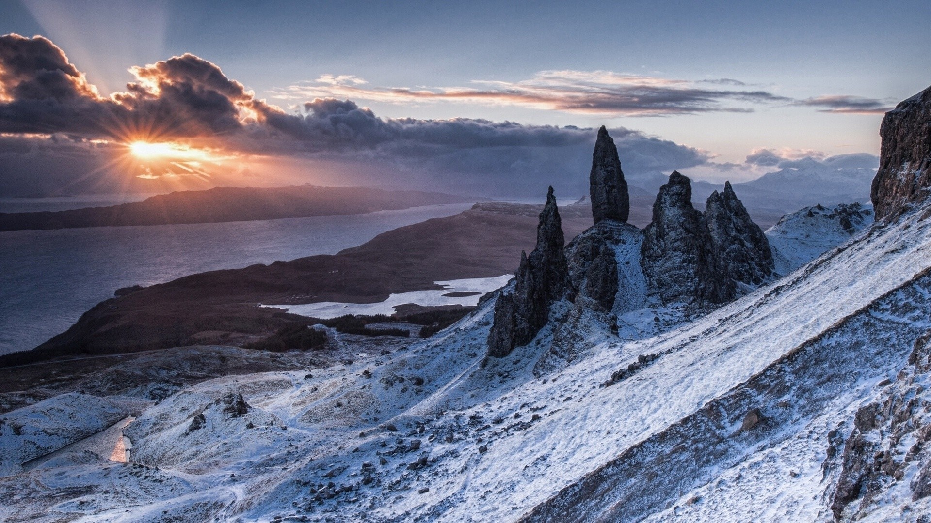 Sunrise over snowy mountains and a lake HD Wallpaper