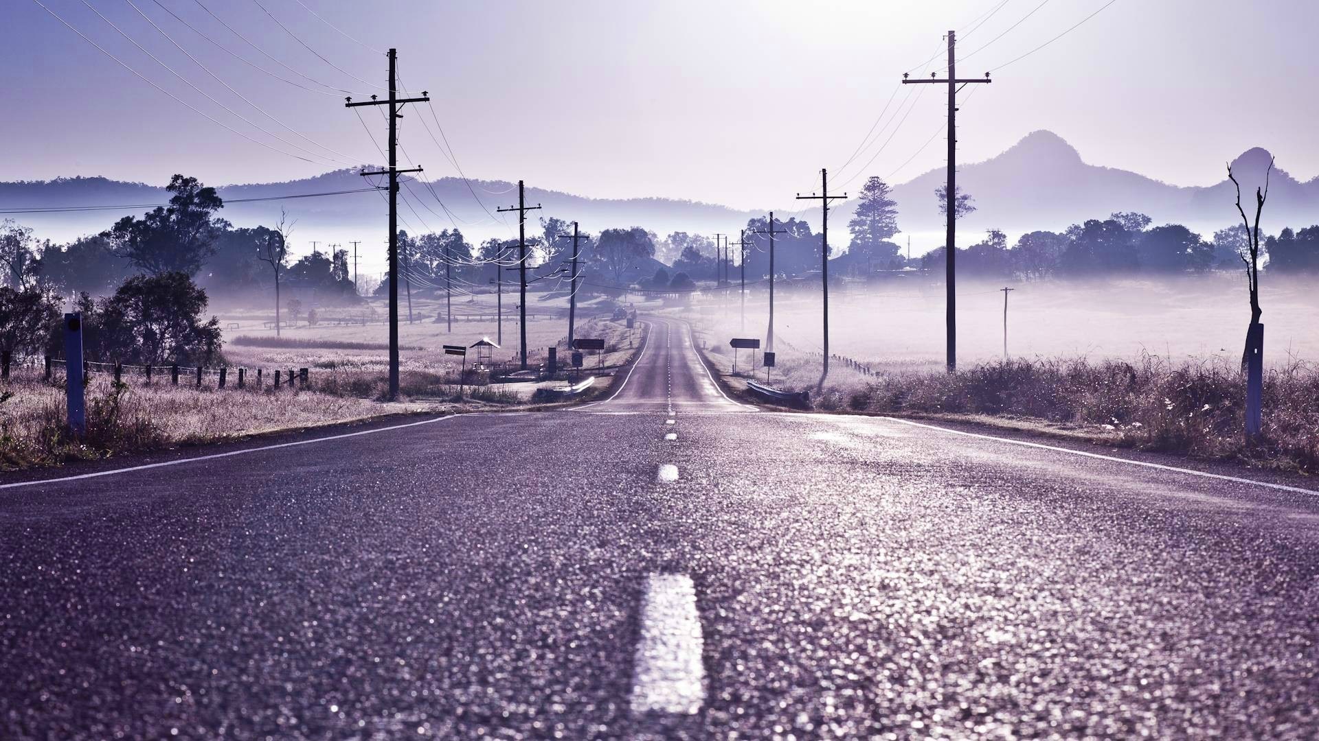 Empty road with power lines and fog HD Wallpaper