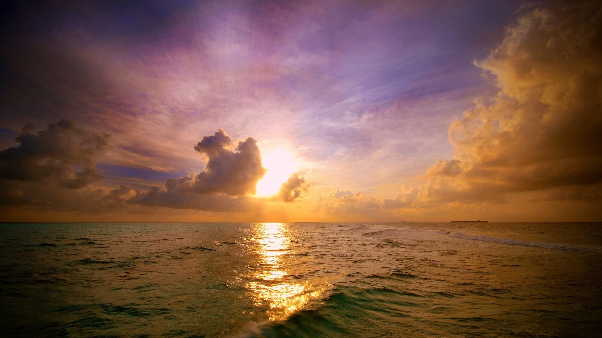 Sunset over the ocean with colorful clouds and waves HD Wallpaper