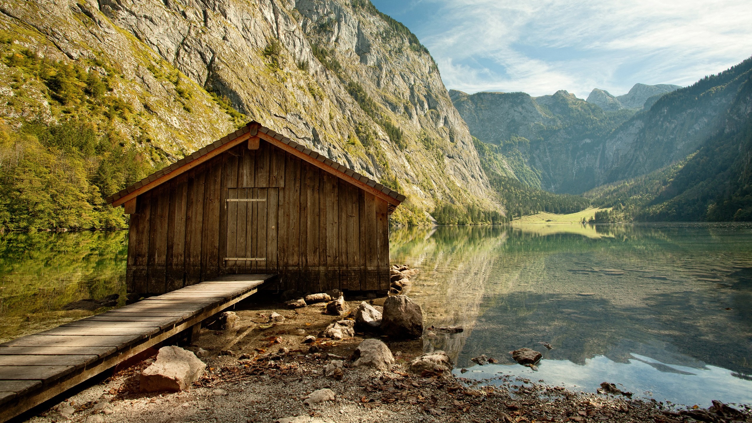 Wooden boathouse on a clear lake with mountains HD Wallpaper