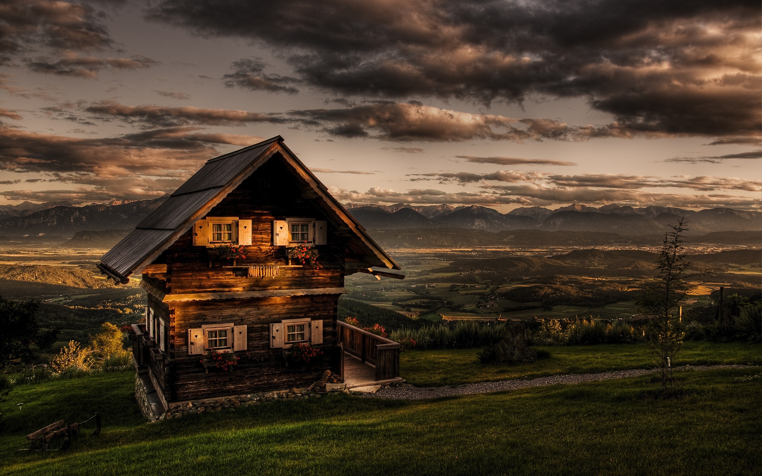Wooden house on a hill at sunset with mountains HD Wallpaper