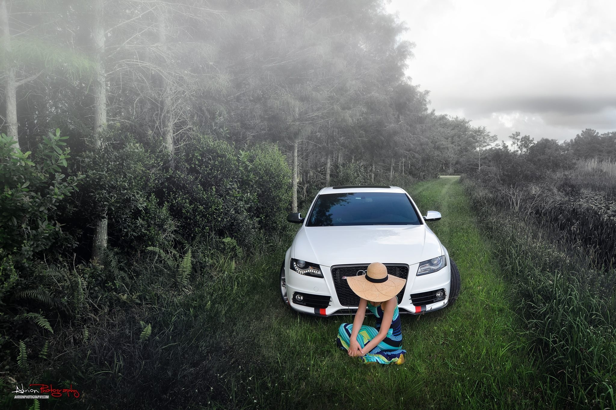 Woman in hat by white Audi car in foggy forest HD Wallpaper