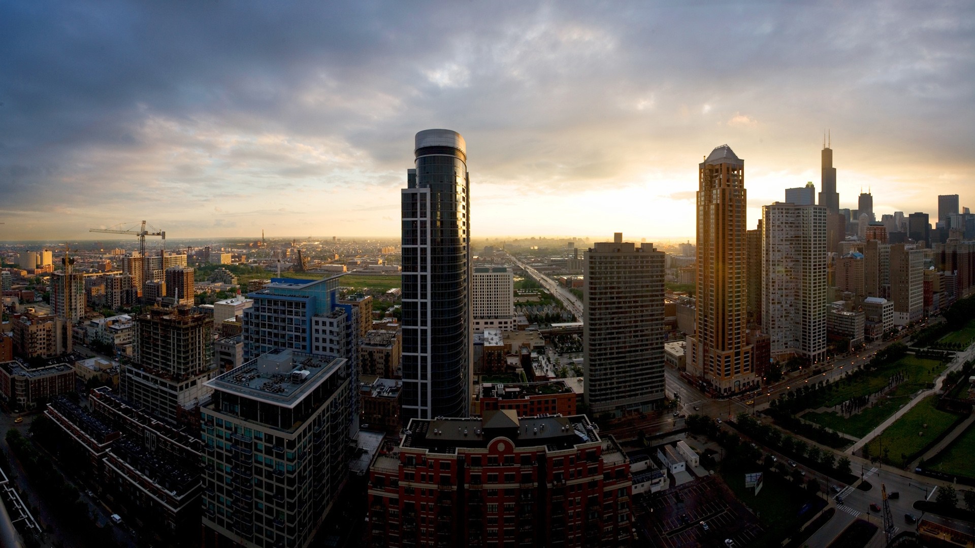 Panoramic city skyline at sunset with skyscrapers and clouds HD Wallpaper