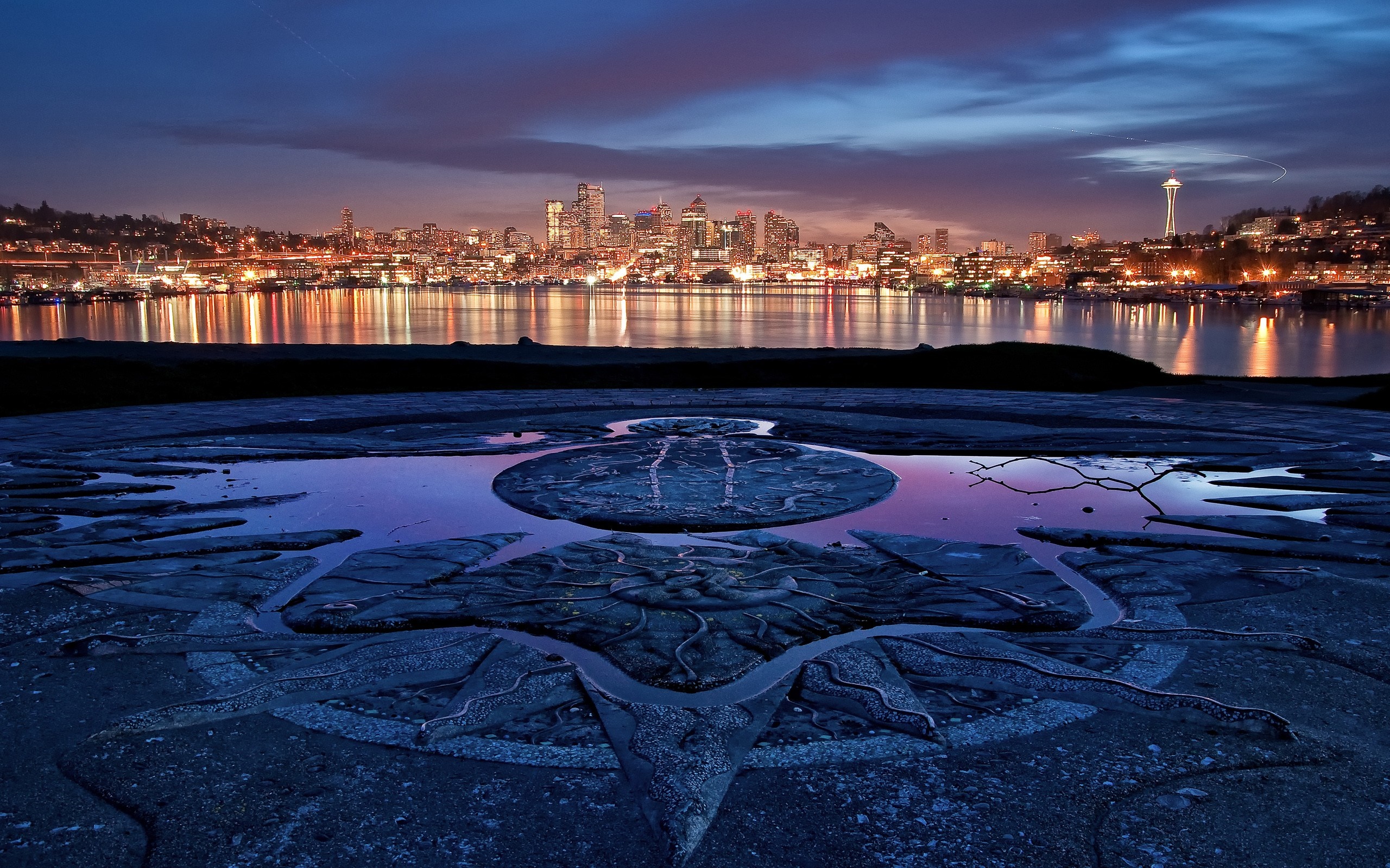 Seattle skyline at dusk with a stone carving in the foreground HD Wallpaper