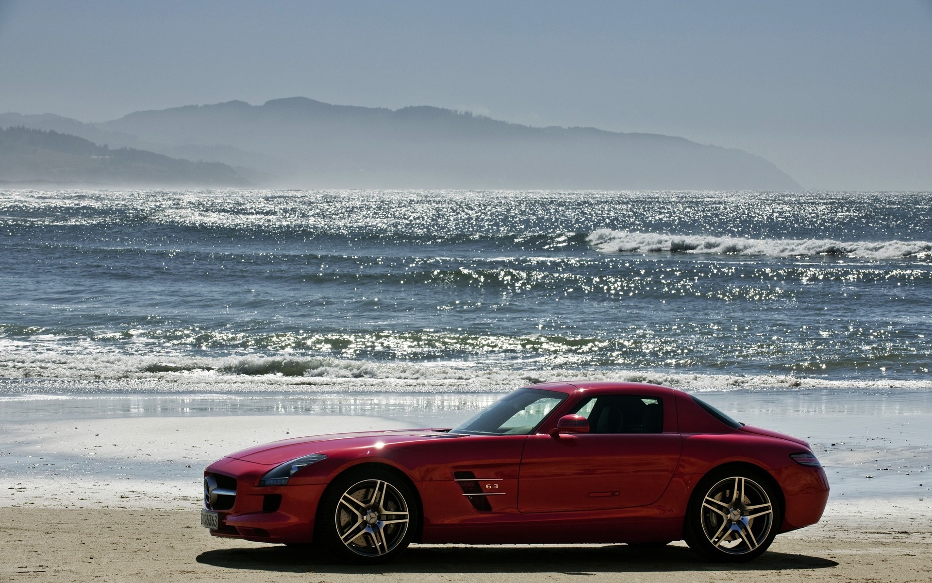 Red Mercedes-Benz SLS AMG parked on a beach HD Wallpaper