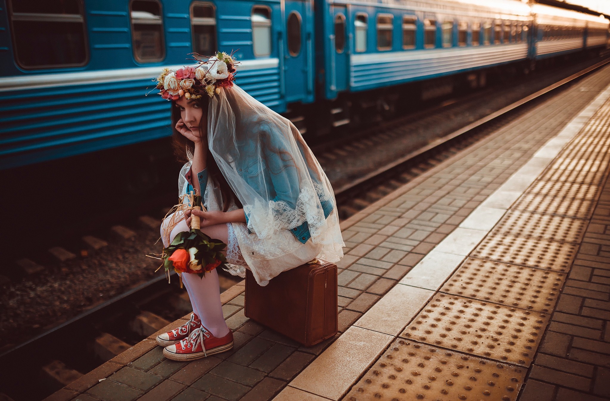 Woman with flower crown and bouquet at train station HD Wallpaper