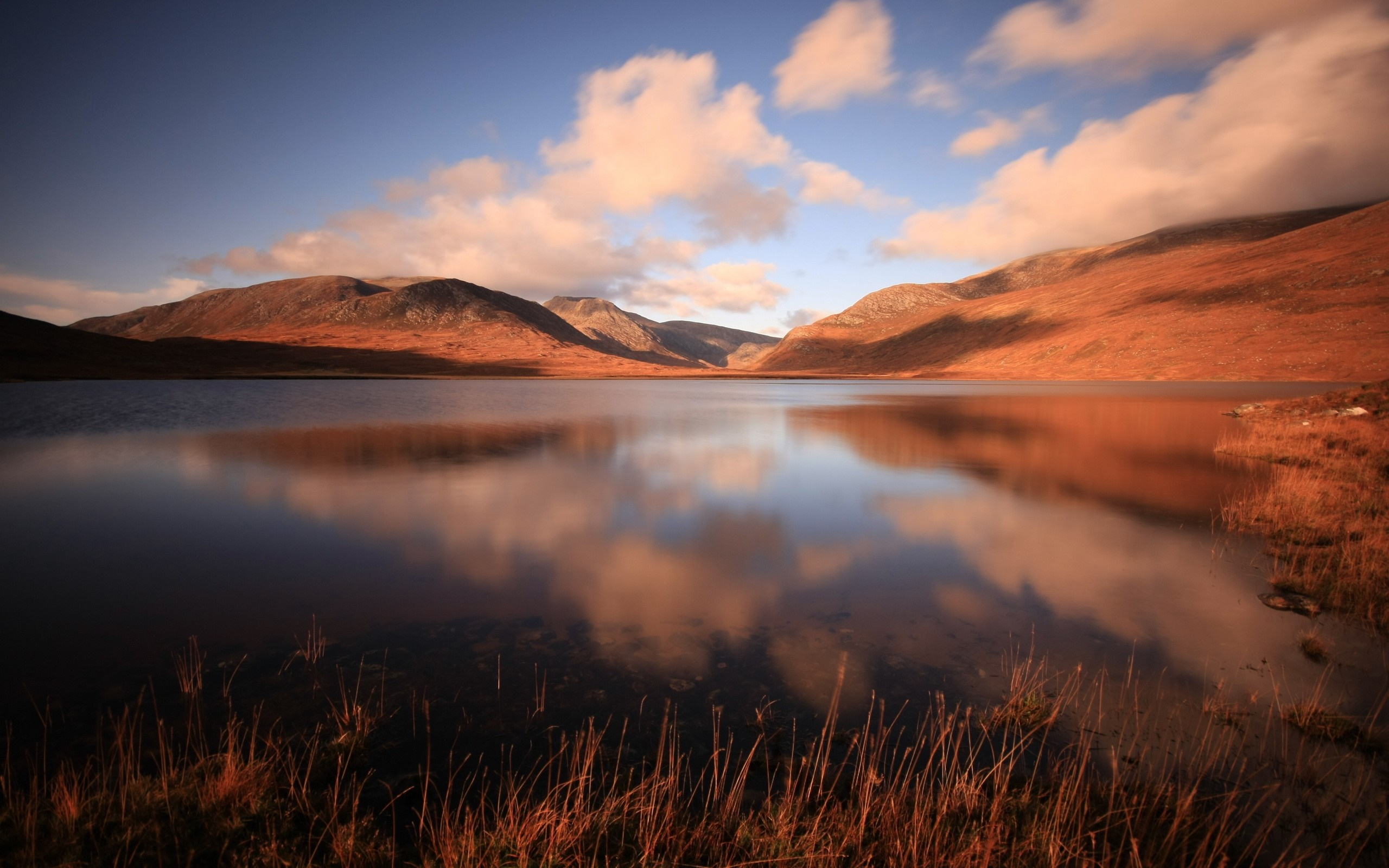 Lake reflecting mountains and clouds at sunset HD Wallpaper