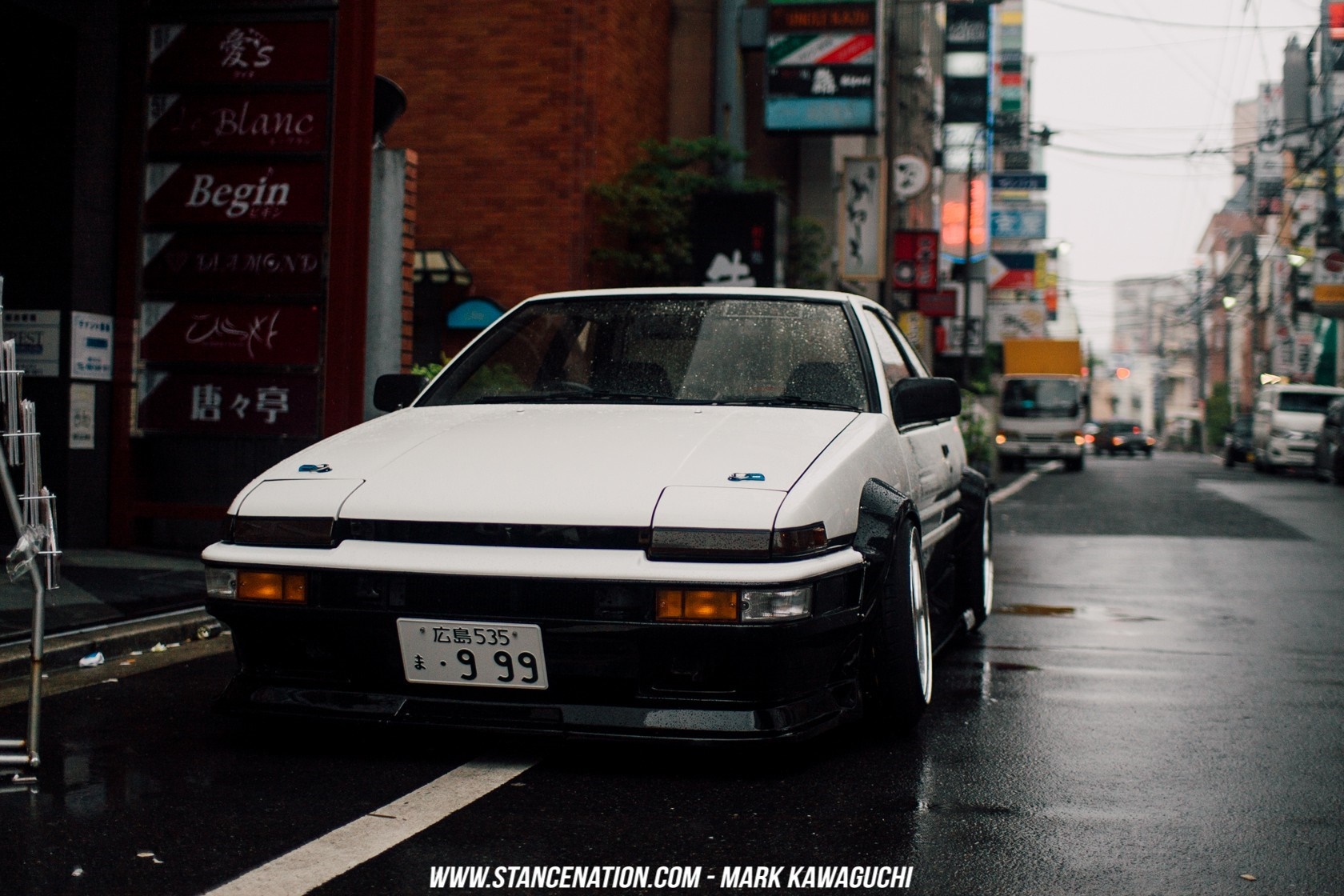 White Toyota AE86 on a Wet Street in Japan HD Wallpaper