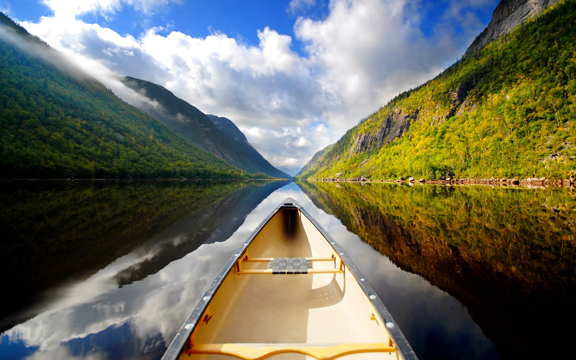 Canoe on a calm lake between mountains HD Wallpaper