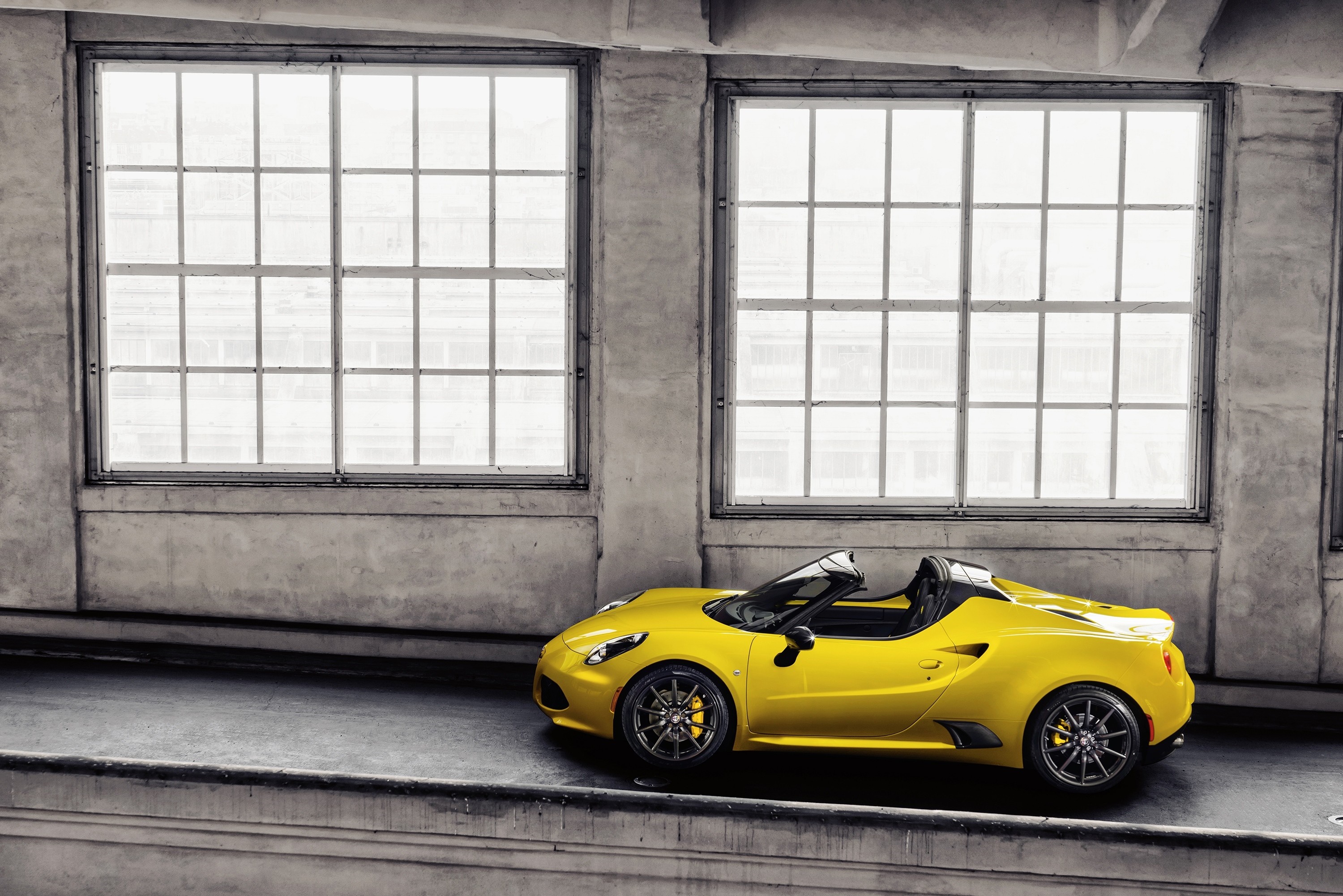 Yellow Alfa Romeo 4C Spider parked indoors HD Wallpaper