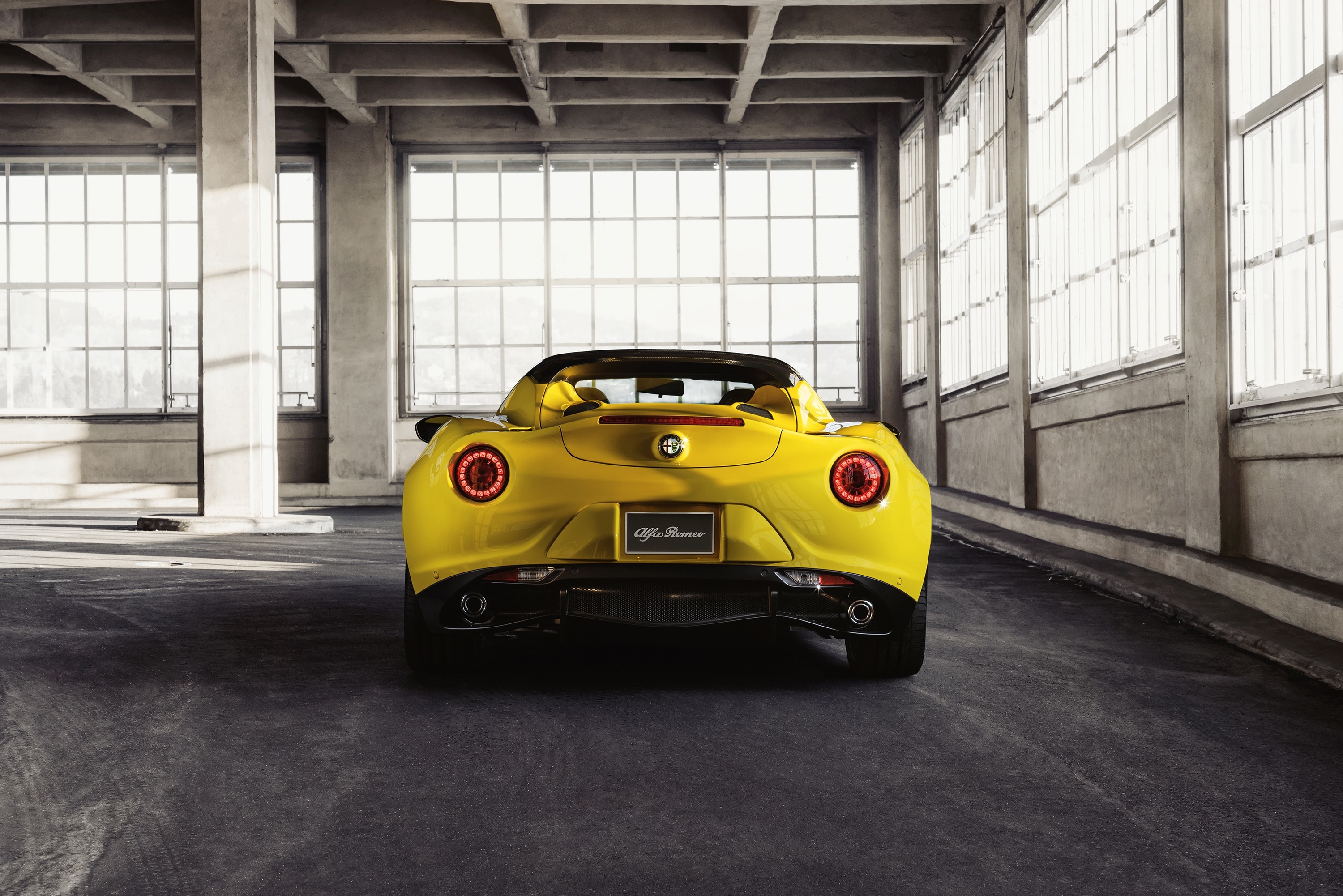 Yellow Alfa Romeo 4C Spider in industrial building HD Wallpaper
