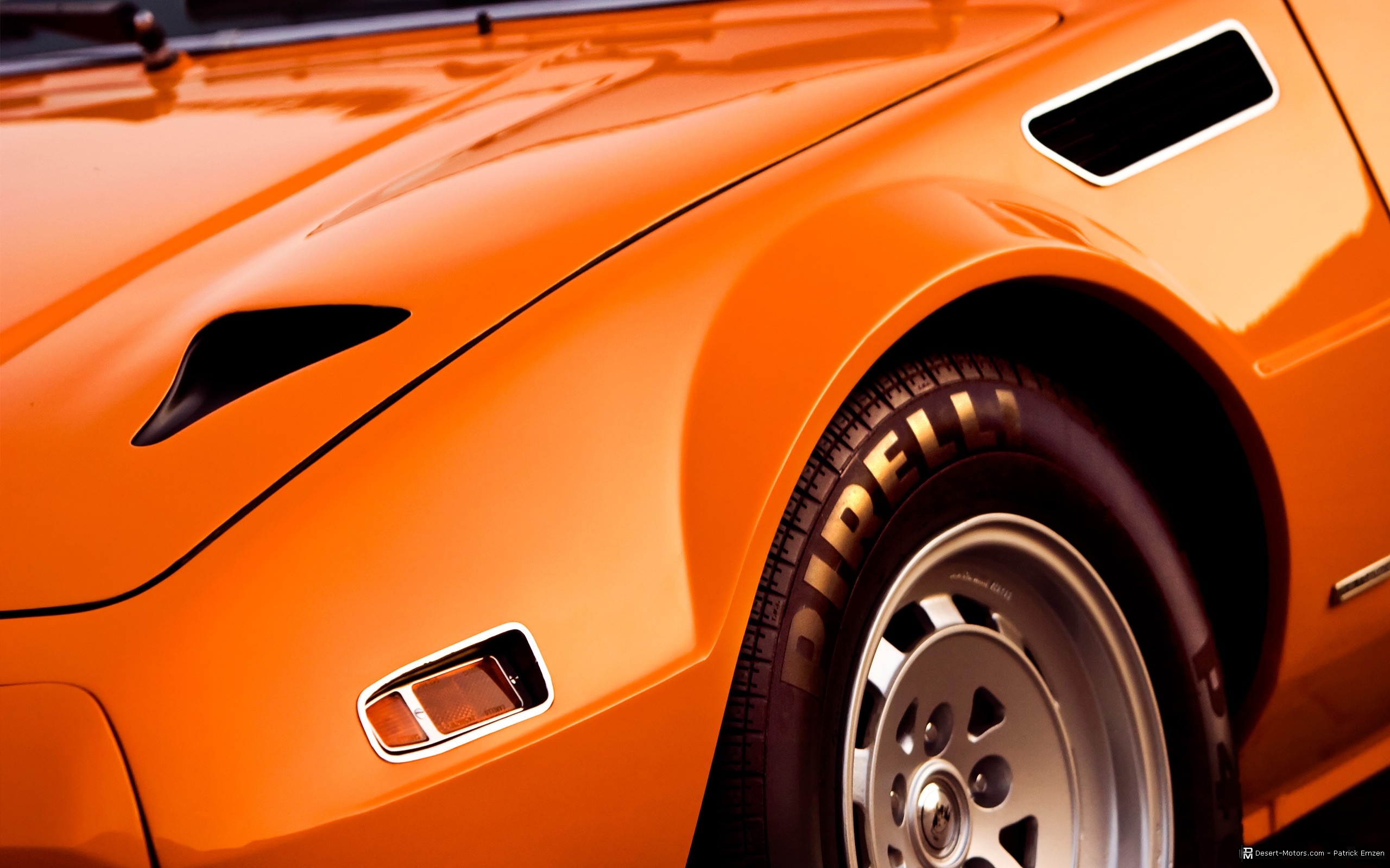 Orange sports car fender and wheel with Pirelli tires HD Wallpaper