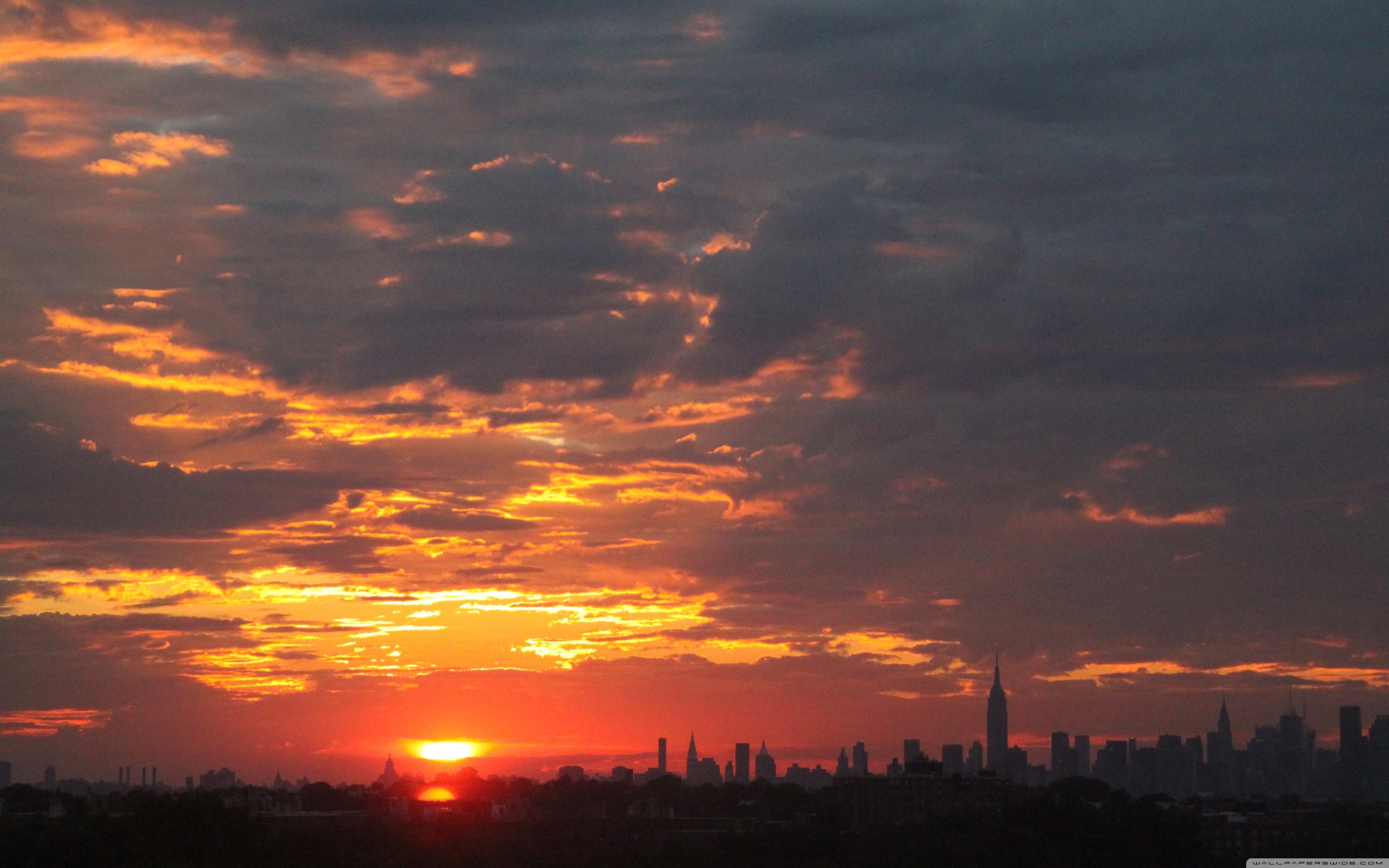 Sunset over a city skyline HD Wallpaper
