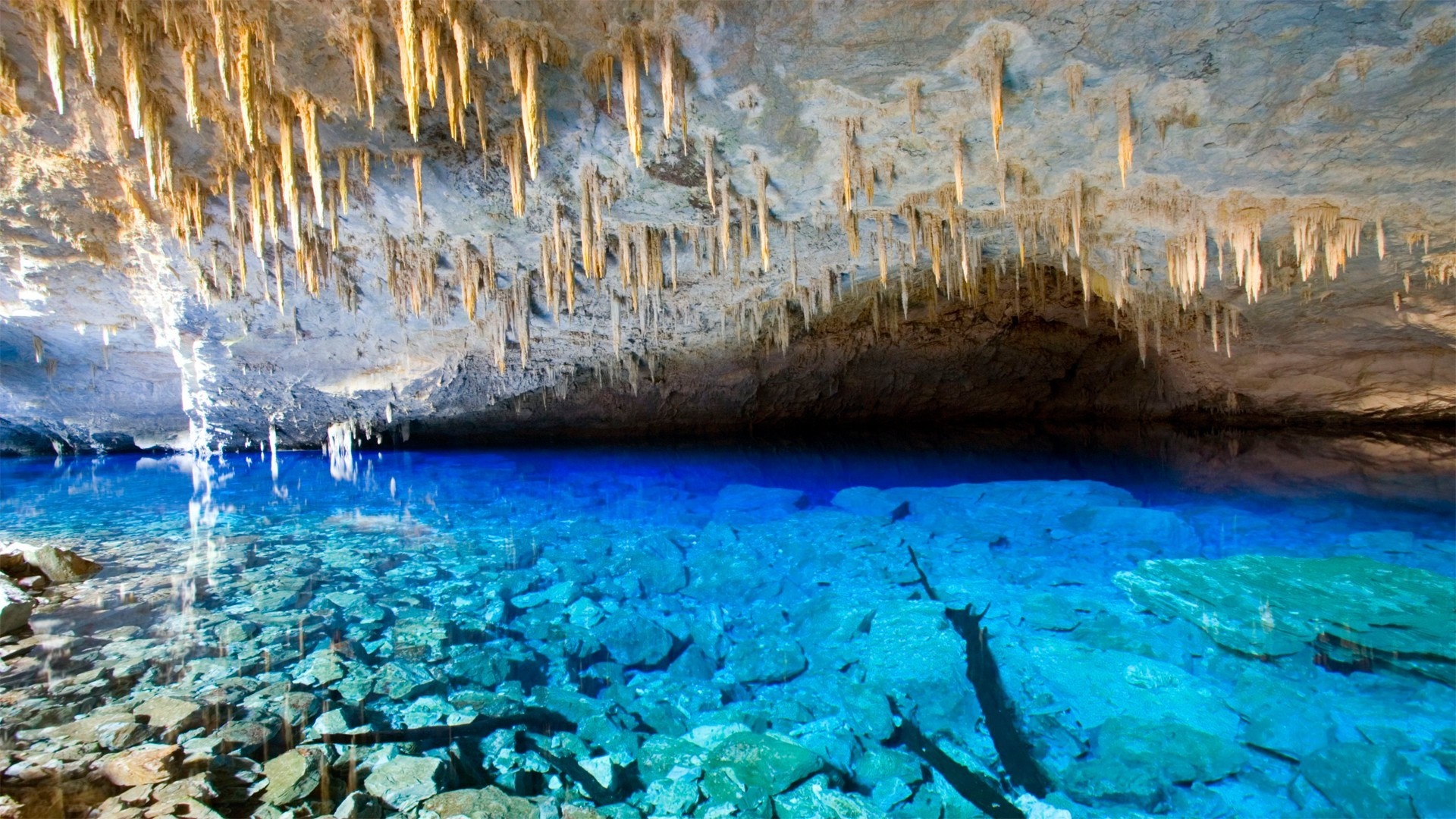 Cave with stalactites and clear blue water HD Wallpaper